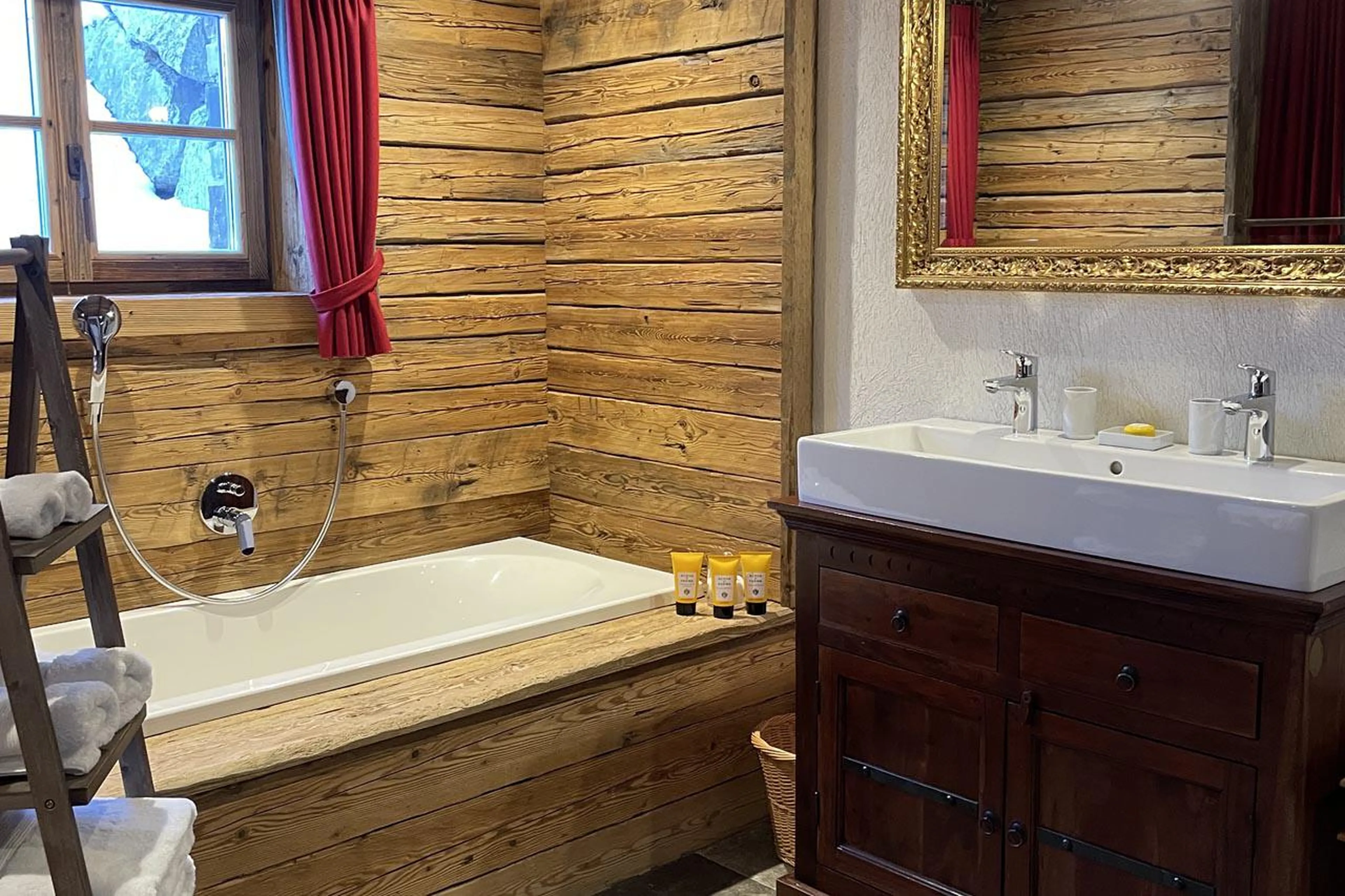 En-suite bathroom with bath and shower at Chalet Tschoder in St Anton