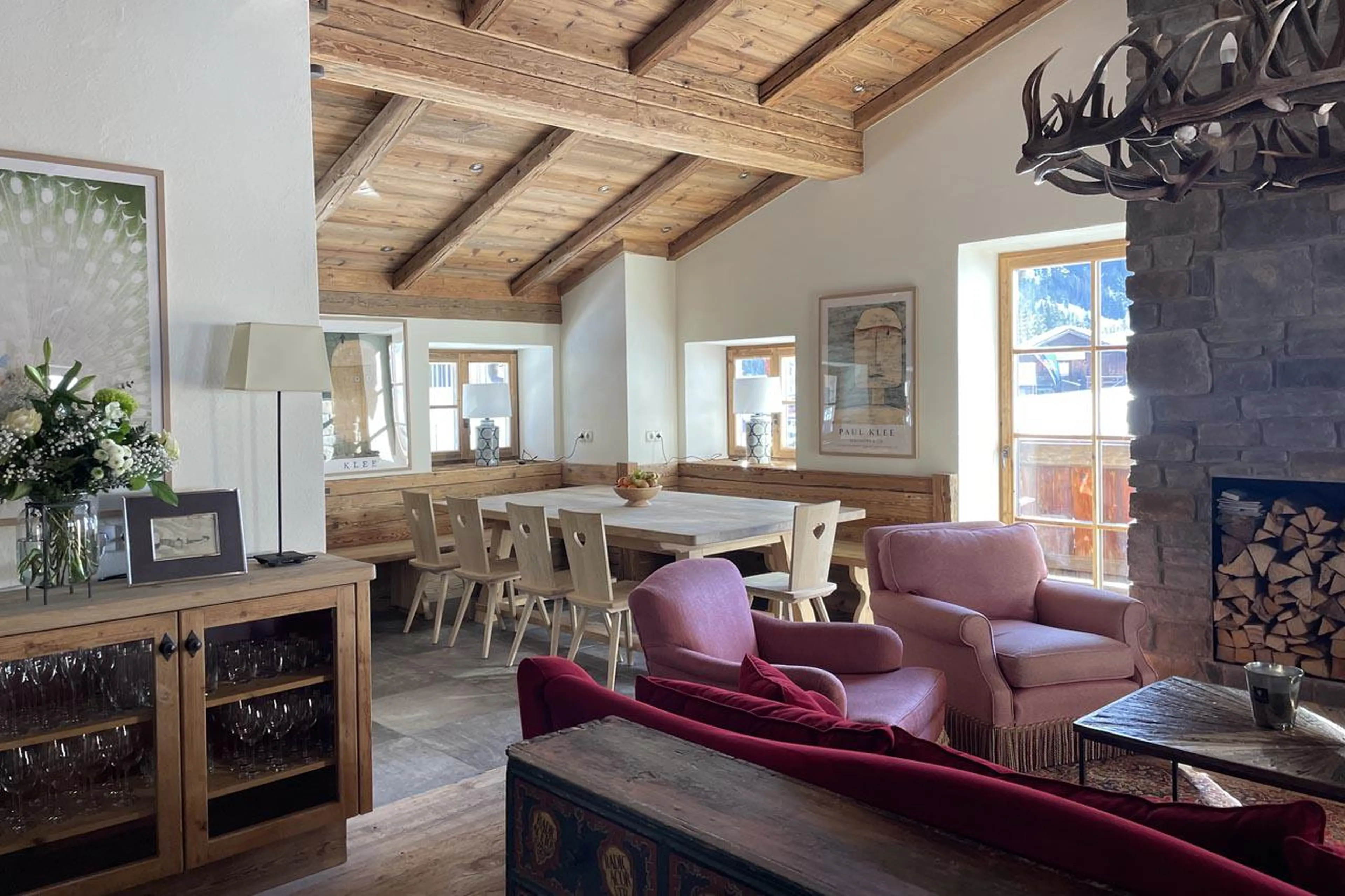 Open-plan living space with dining table at Chalet Tschoder in St Anton
