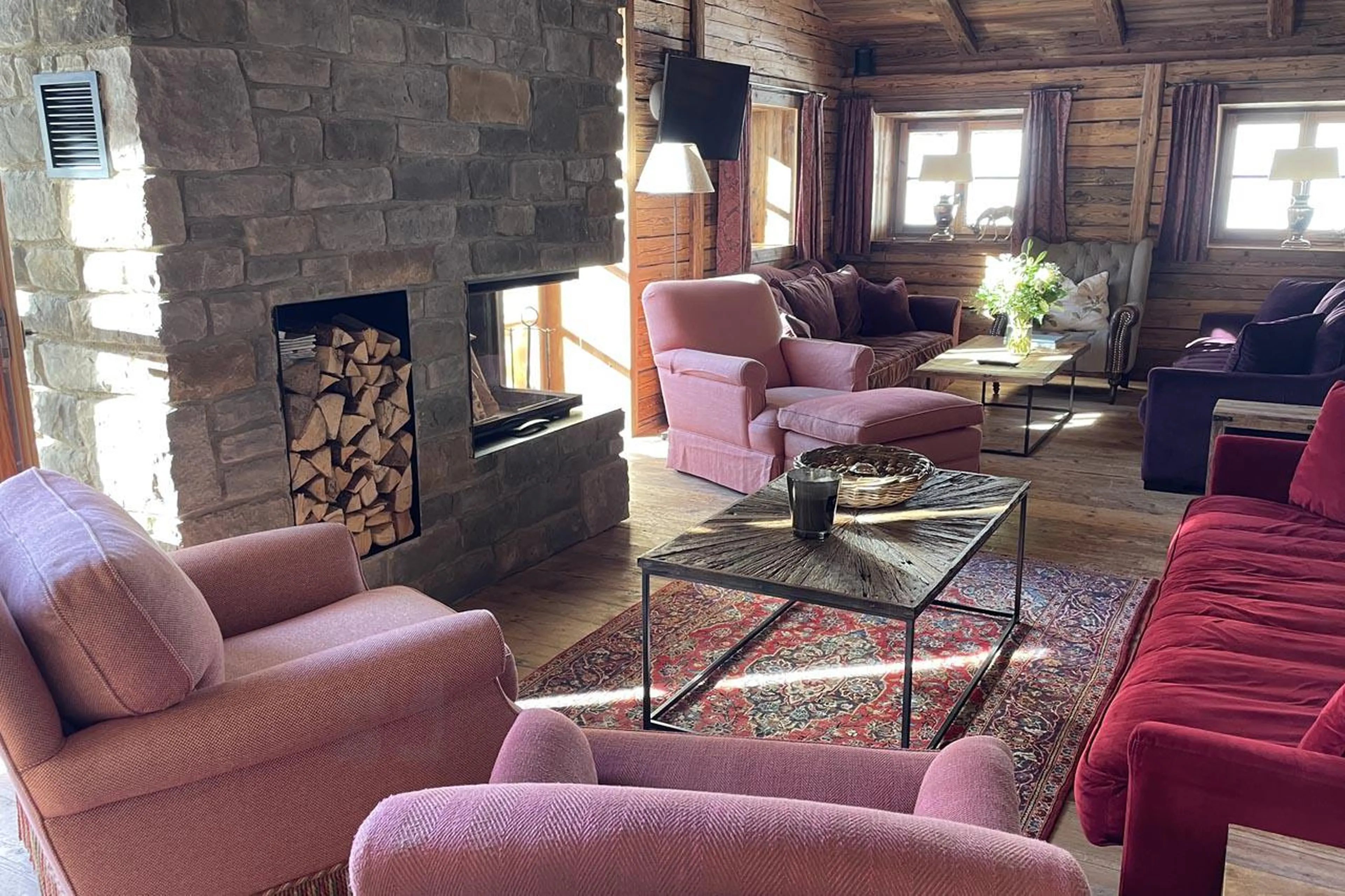 Central fireplace in living and dining area at Chalet Tschoder in St Anton