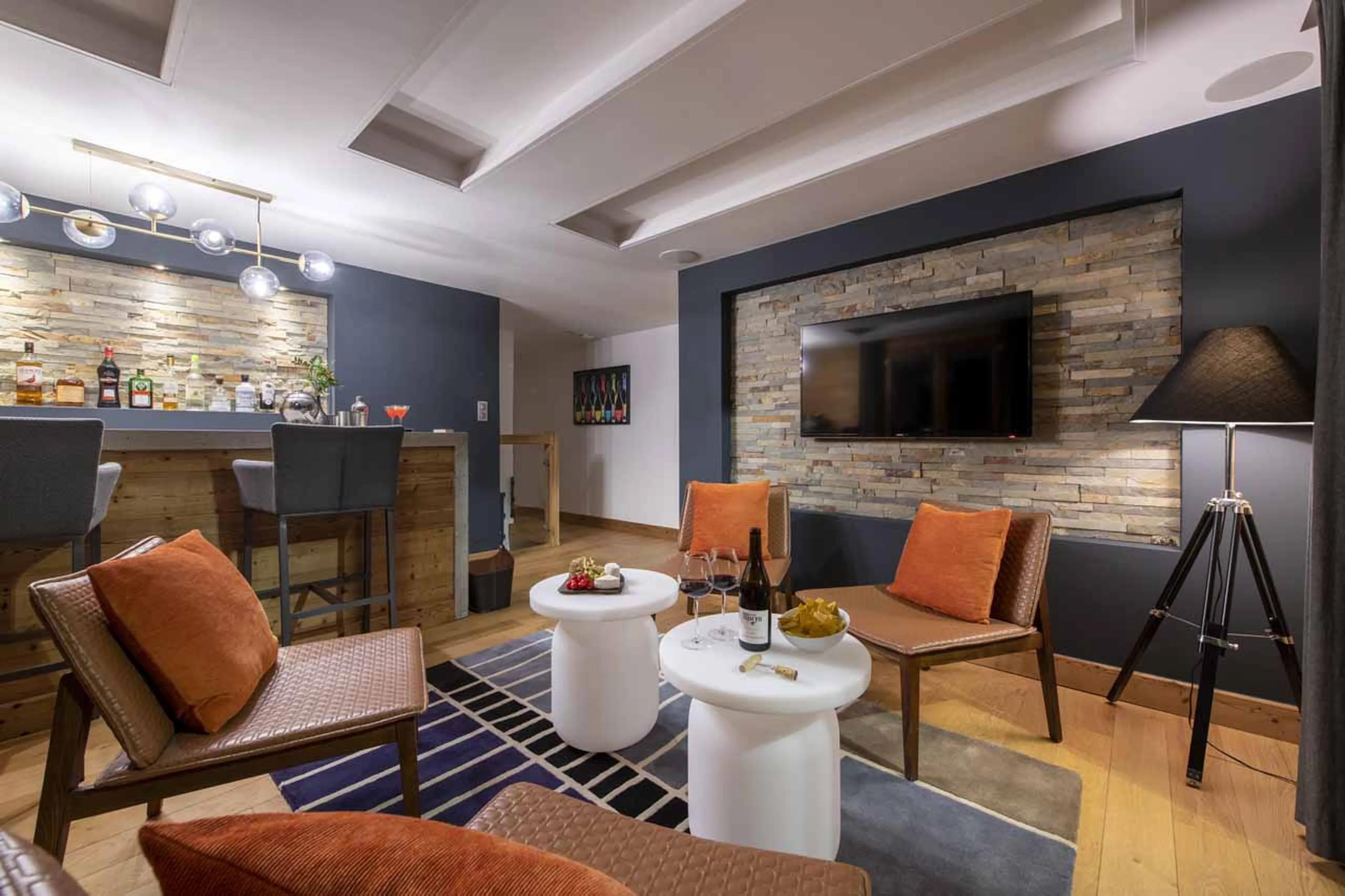 Bar and lounge with large flat screen TV and club seating at Chalet Twenty26 in Morzine