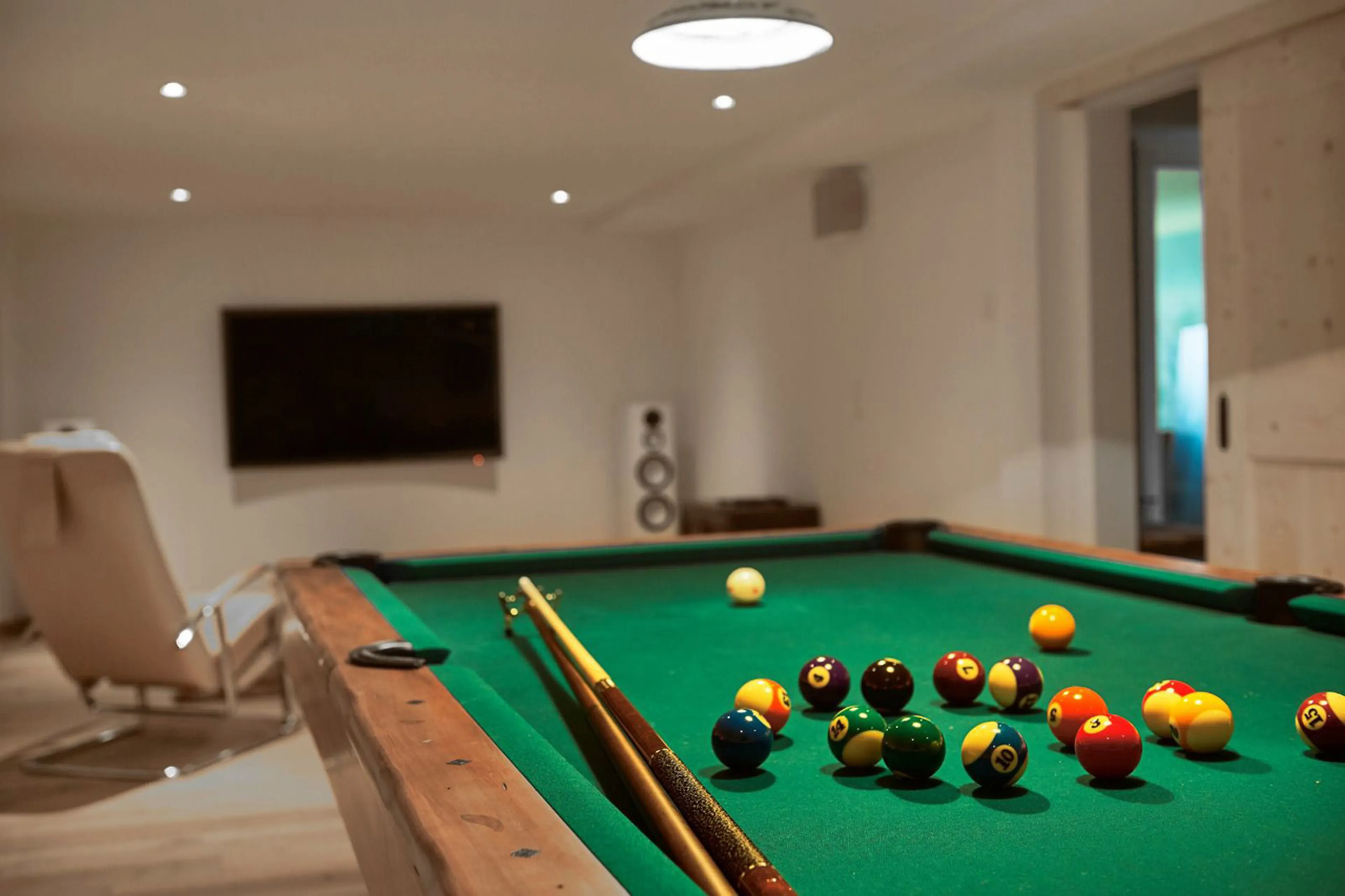 TV and games room with pool table at Chalet Verbena in Klosters