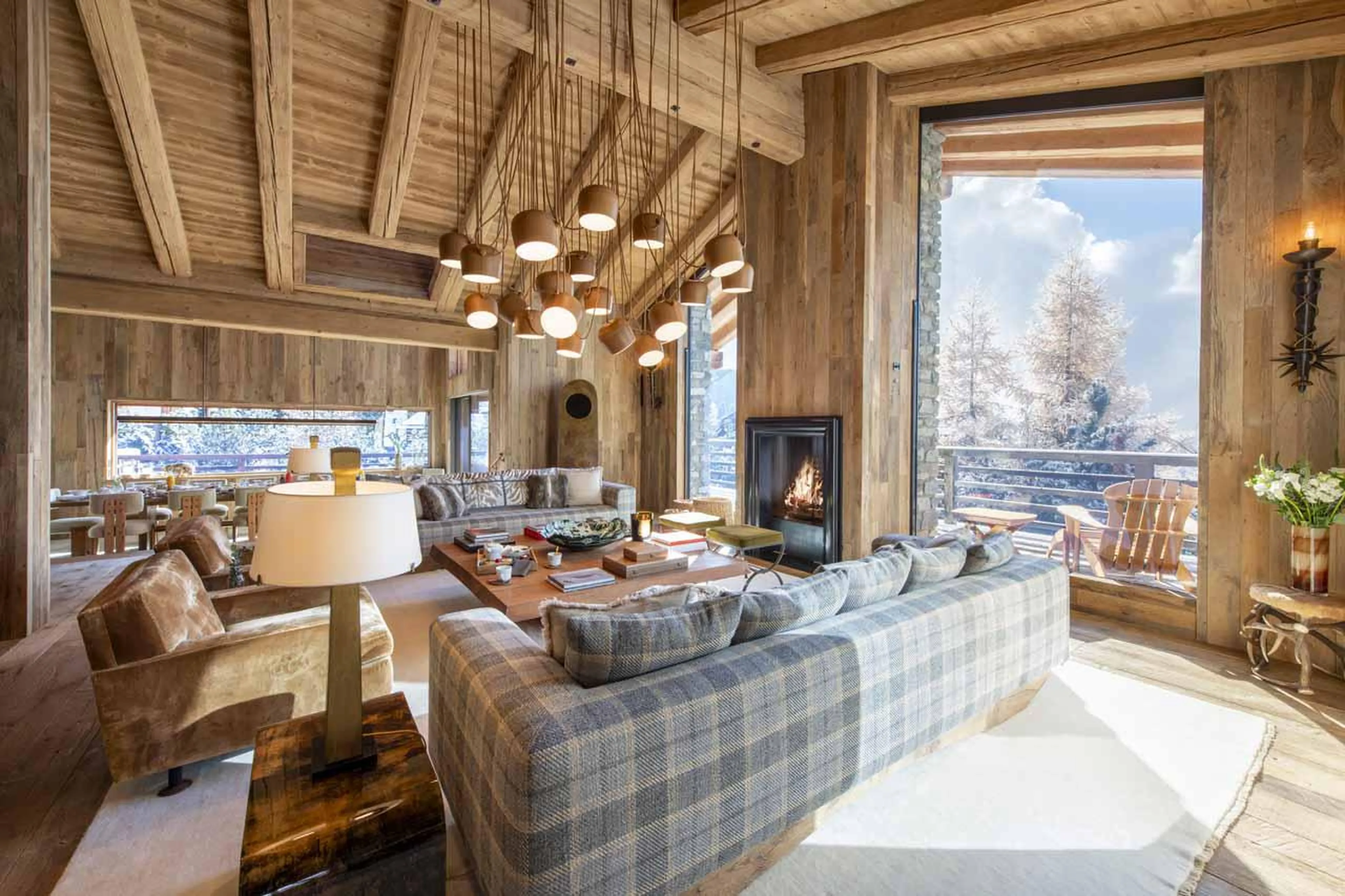 Open plan living area with expansive floor-to-ceiling windows at Chalet Vicuna in Verbier
