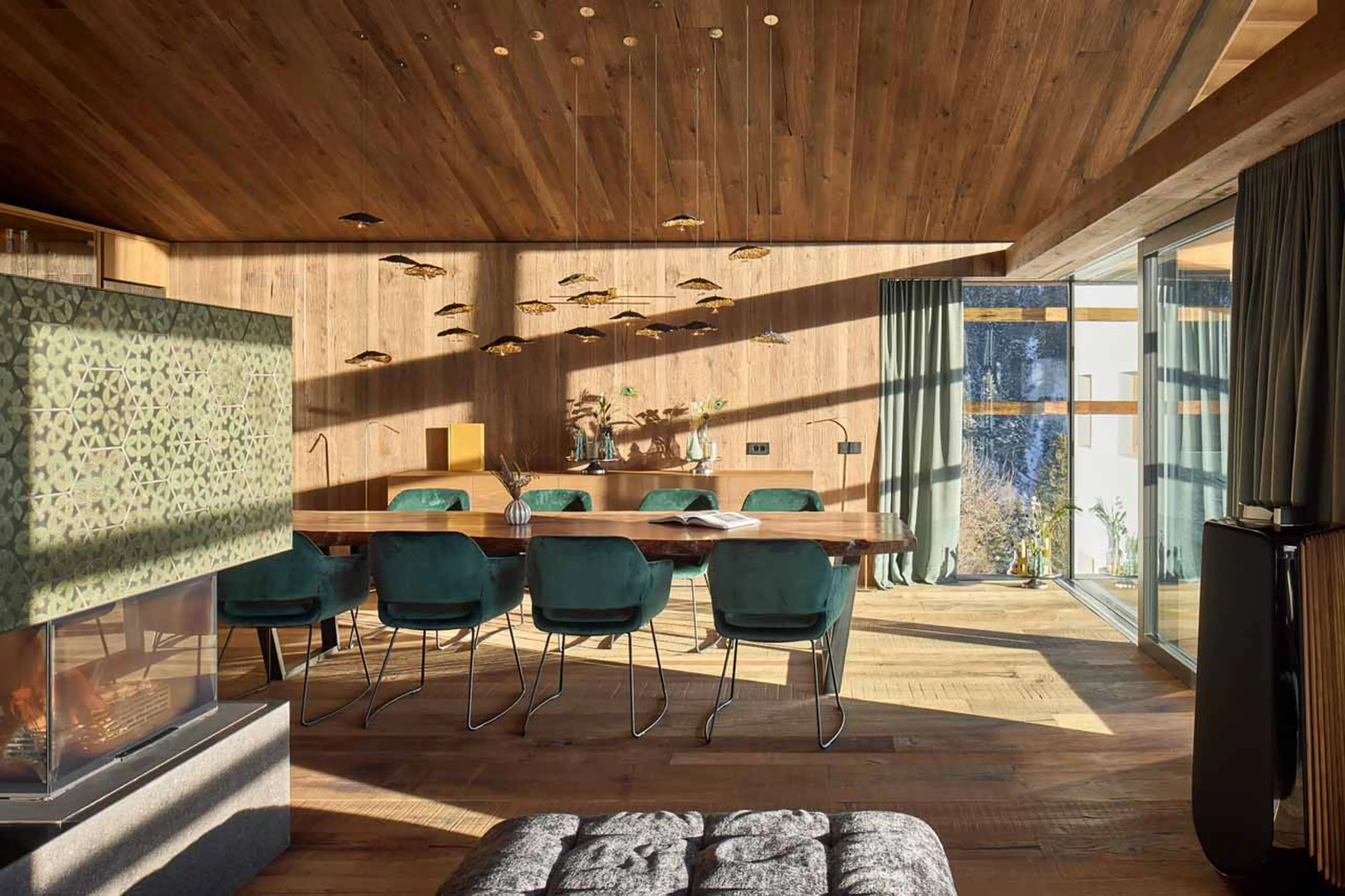 Fireplace dividing living and dining are at Chalet Vilaiet in Val Gardena