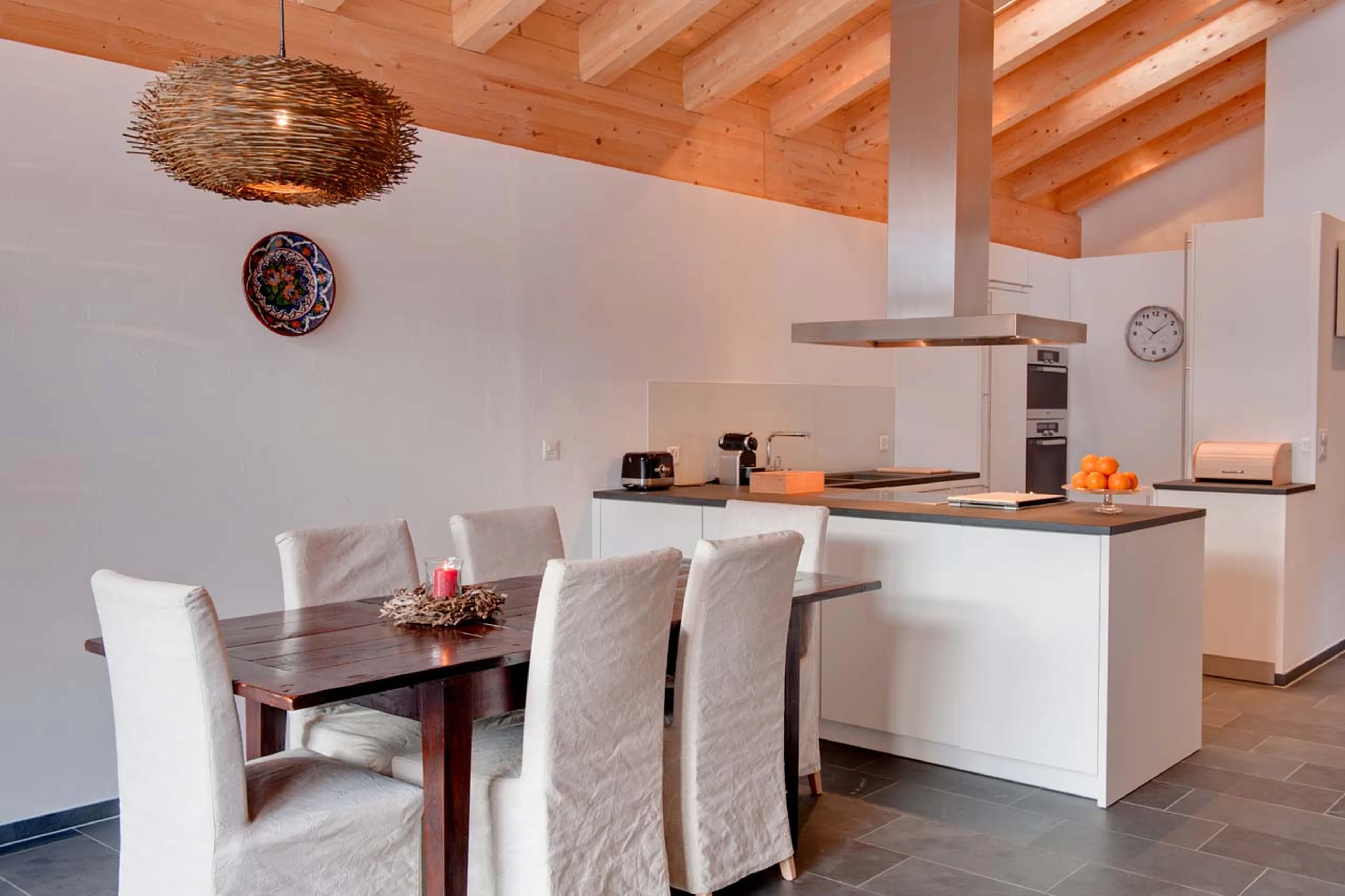 Dining table and kitchen at Chalet Zeus in Zermatt