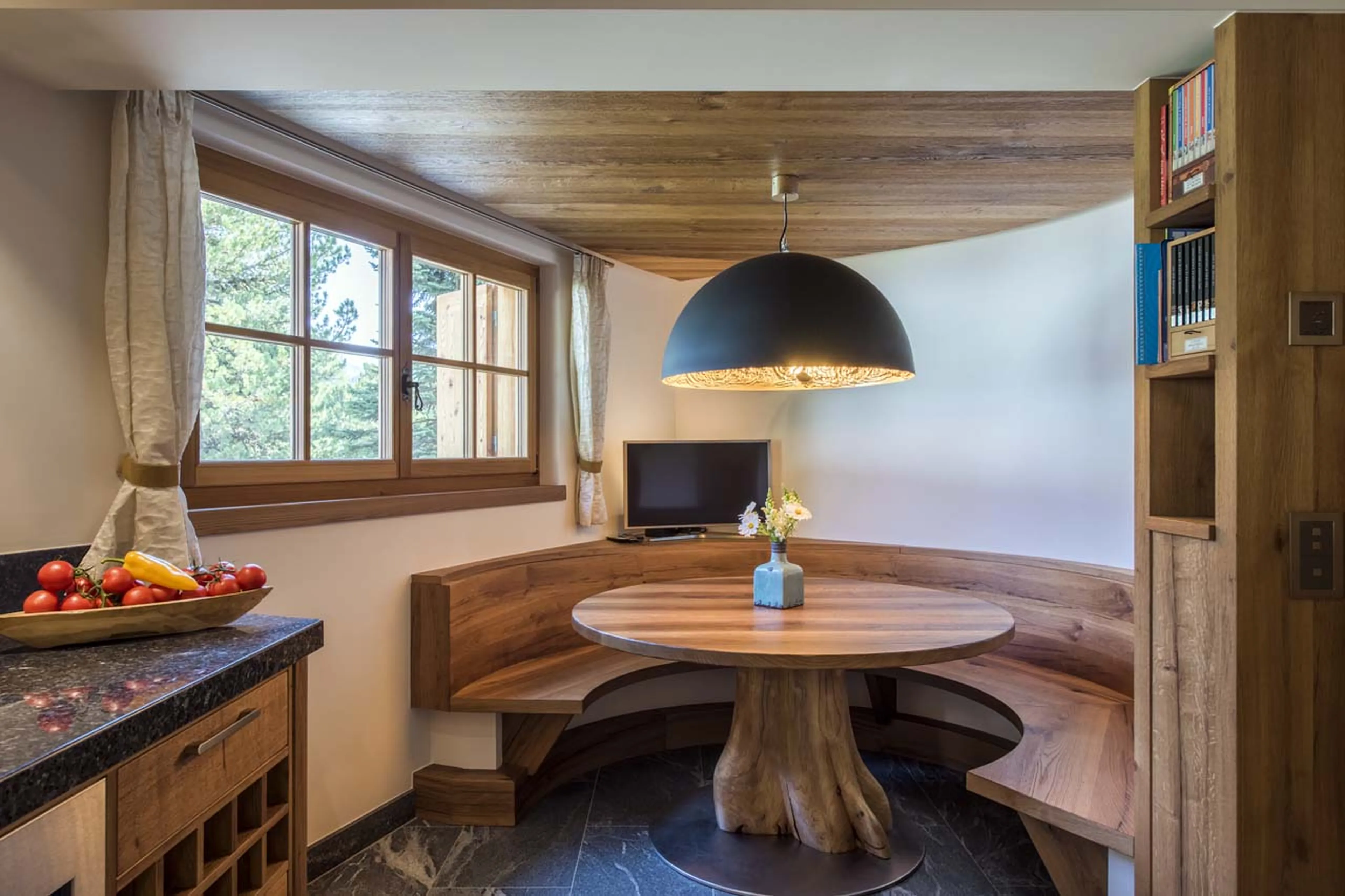 Breakfast table with TV at Chesa El Toula in St Moritz