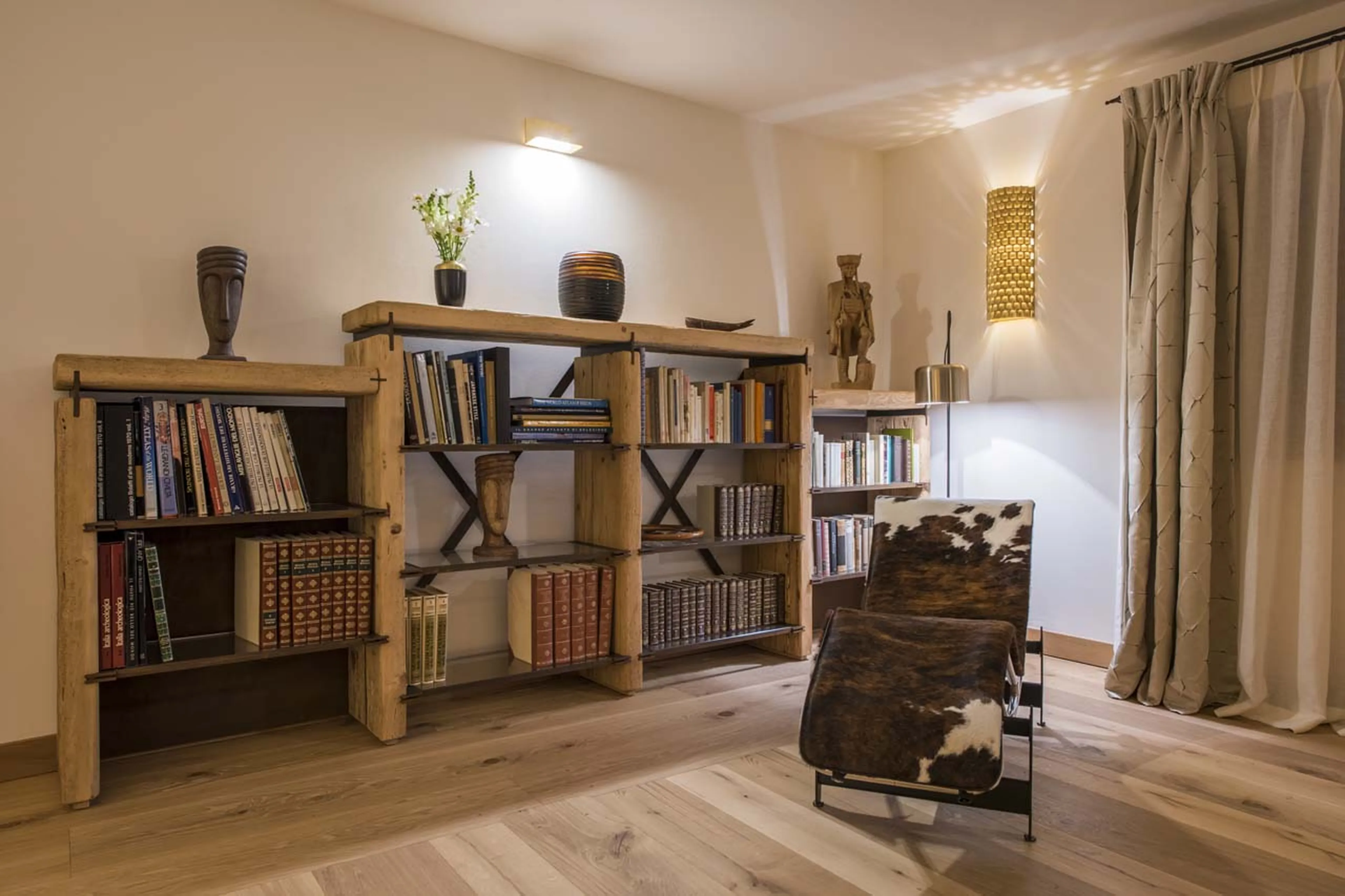 Bookcase in living room at Chesa El Toula in St Moritz