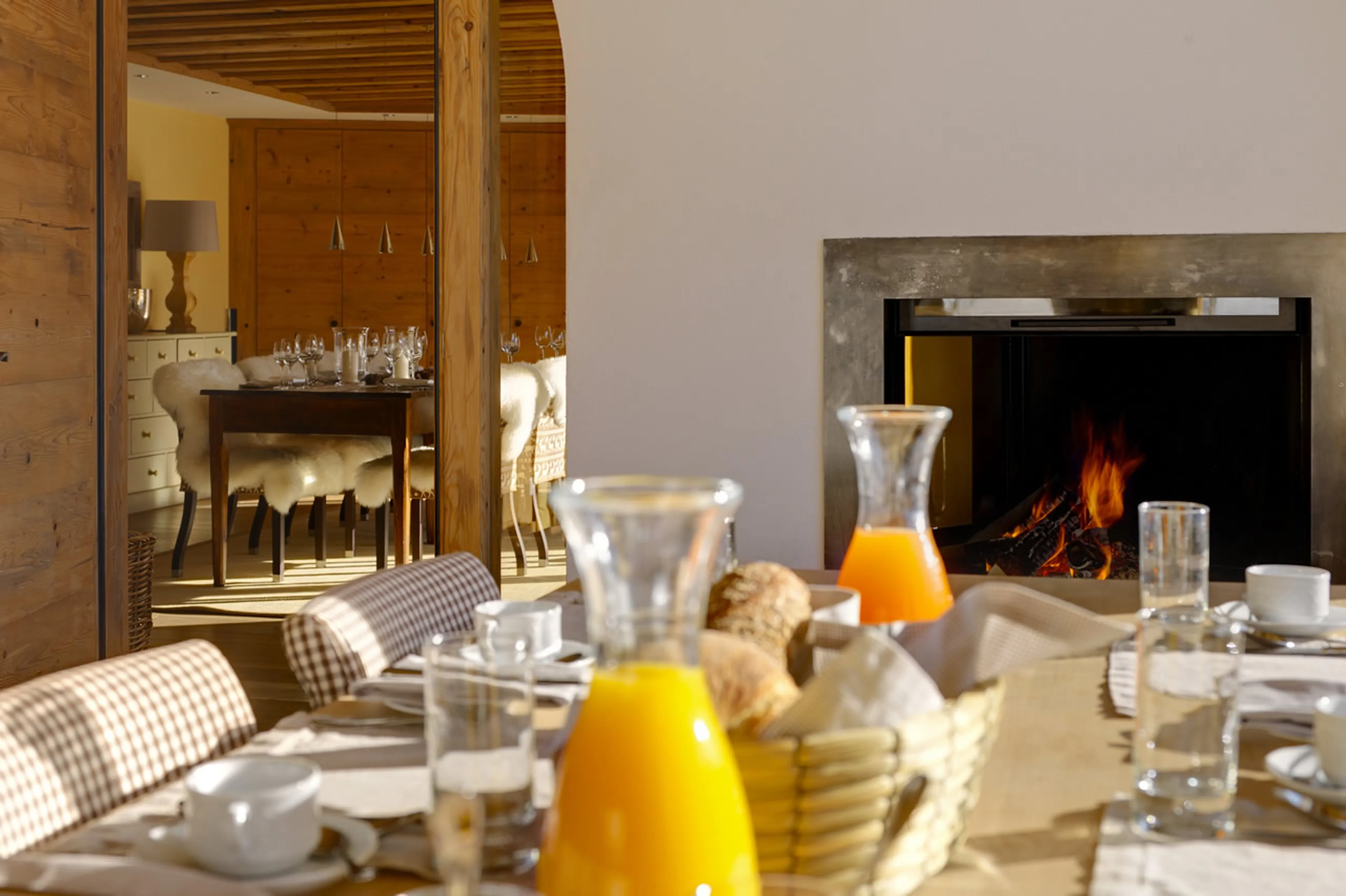 Breakfast table and fireplace in Chesa Falcun in Klosters