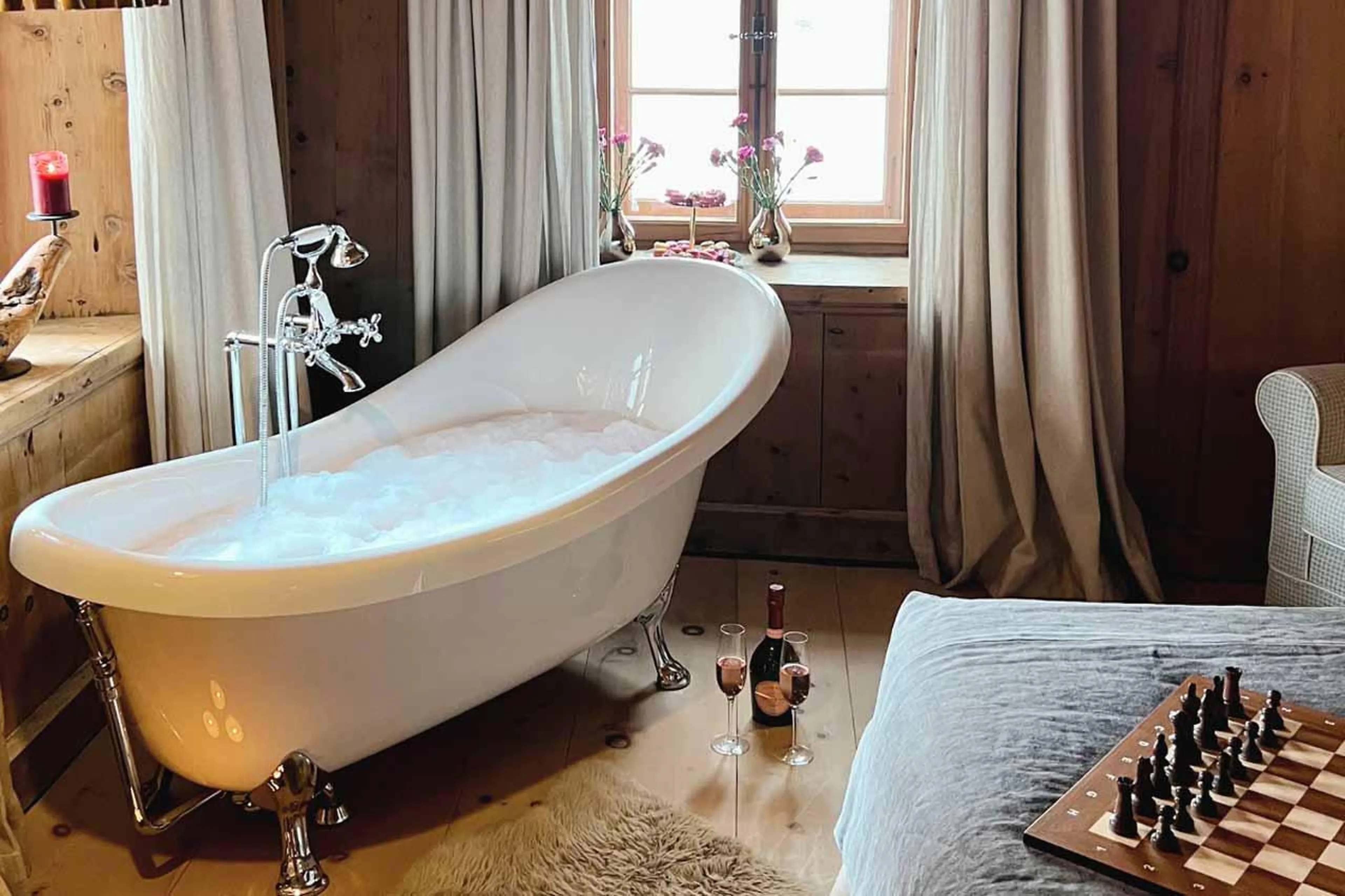 Bathtub in bedroom at Chesa Laret in St Moritz