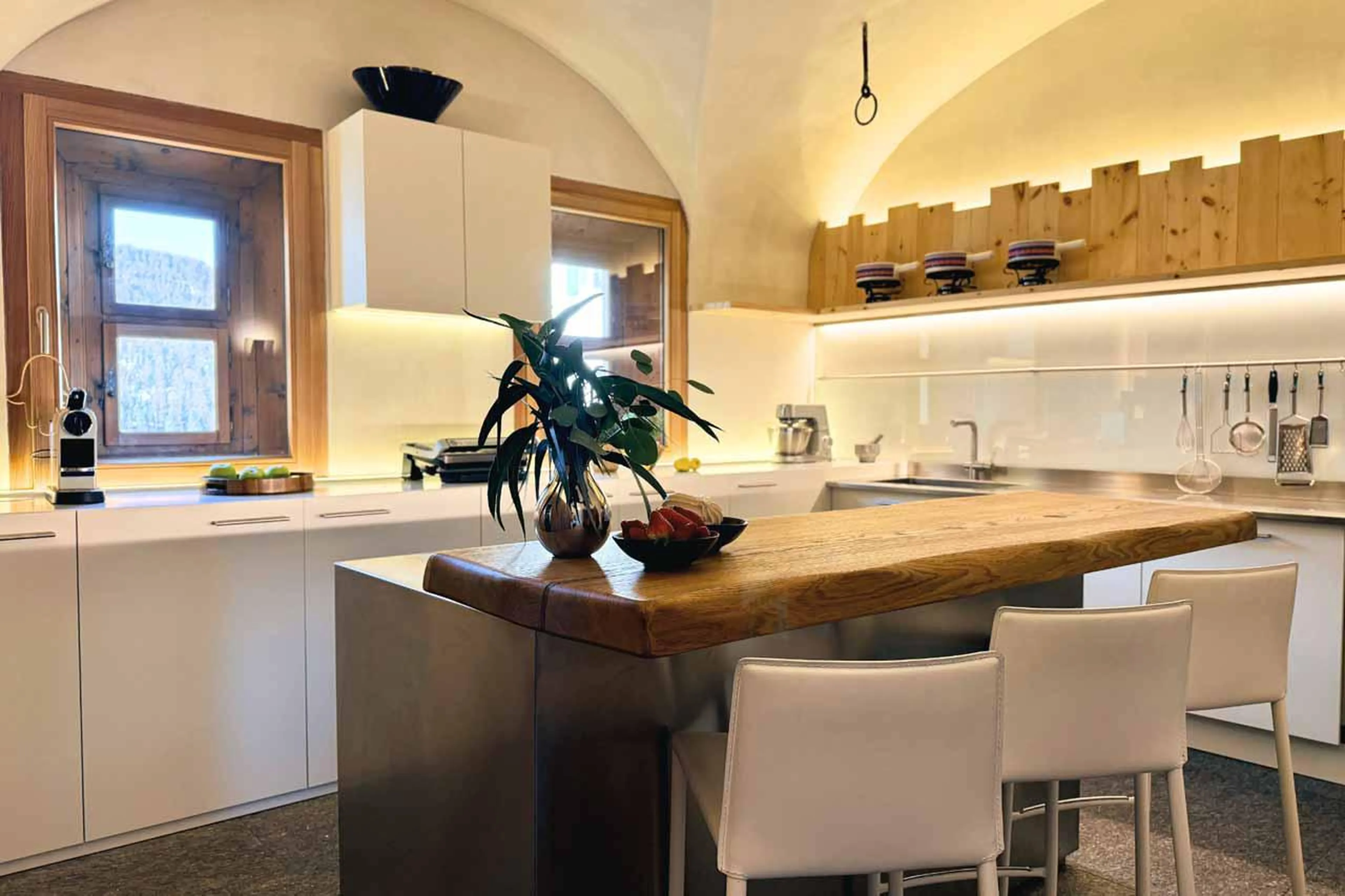 Kitchen with central island at Chesa Laret in St Moritz
