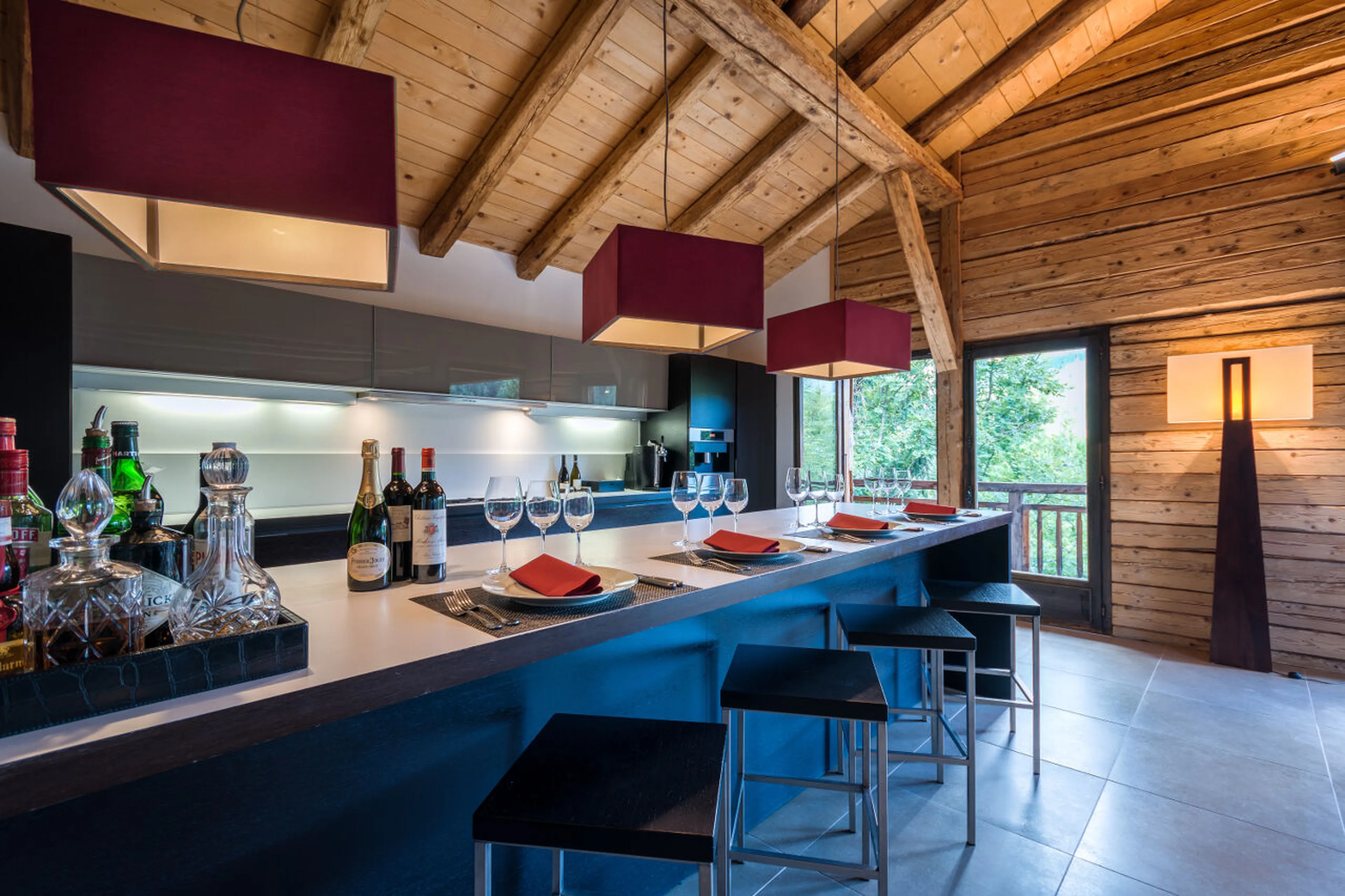 Modern kitchen with breakfast counter in living area in Ferme de Moudon in Les Gets