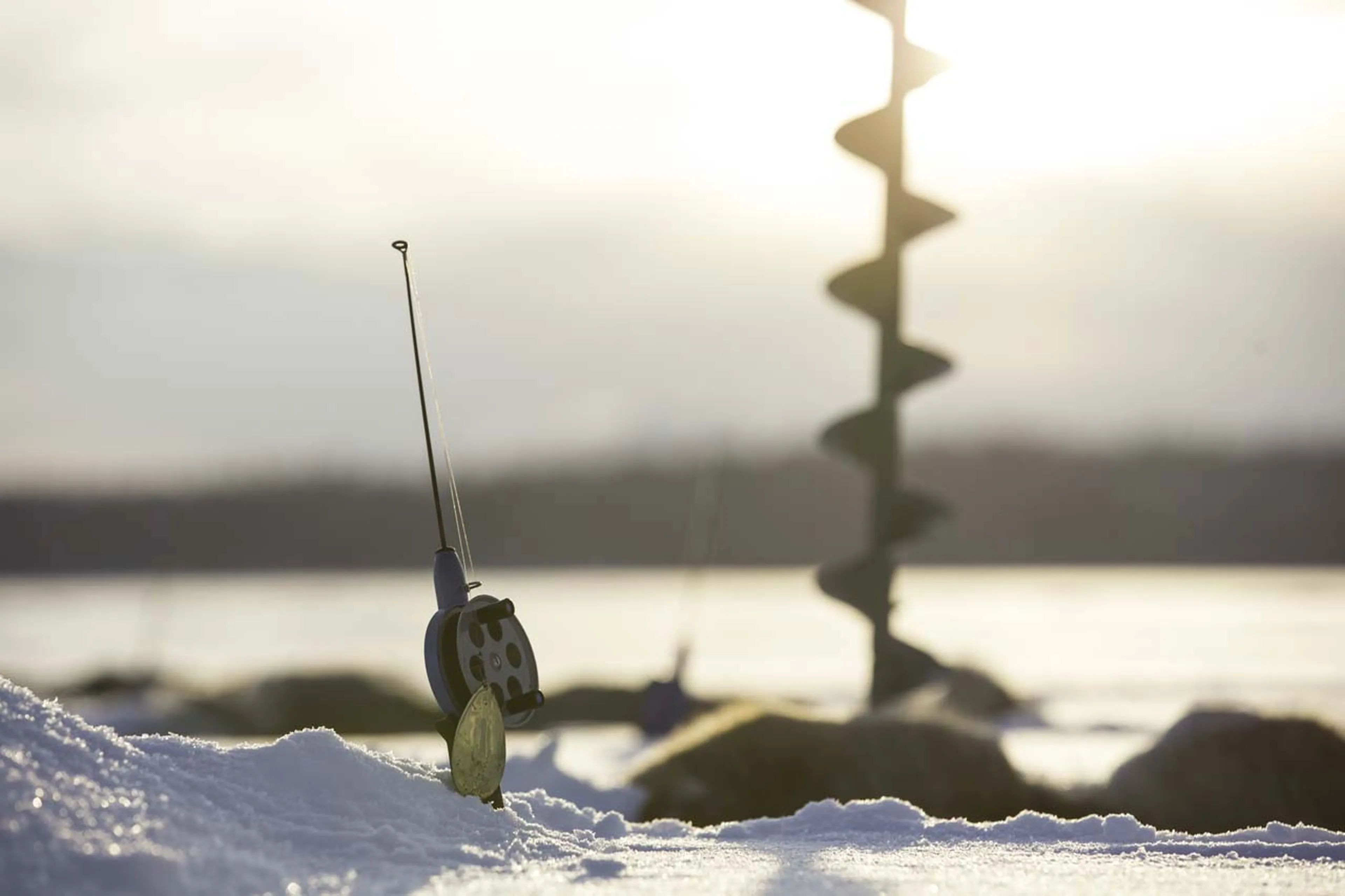Ice fishing at Fjellborg Arctic Lodge in Sweden