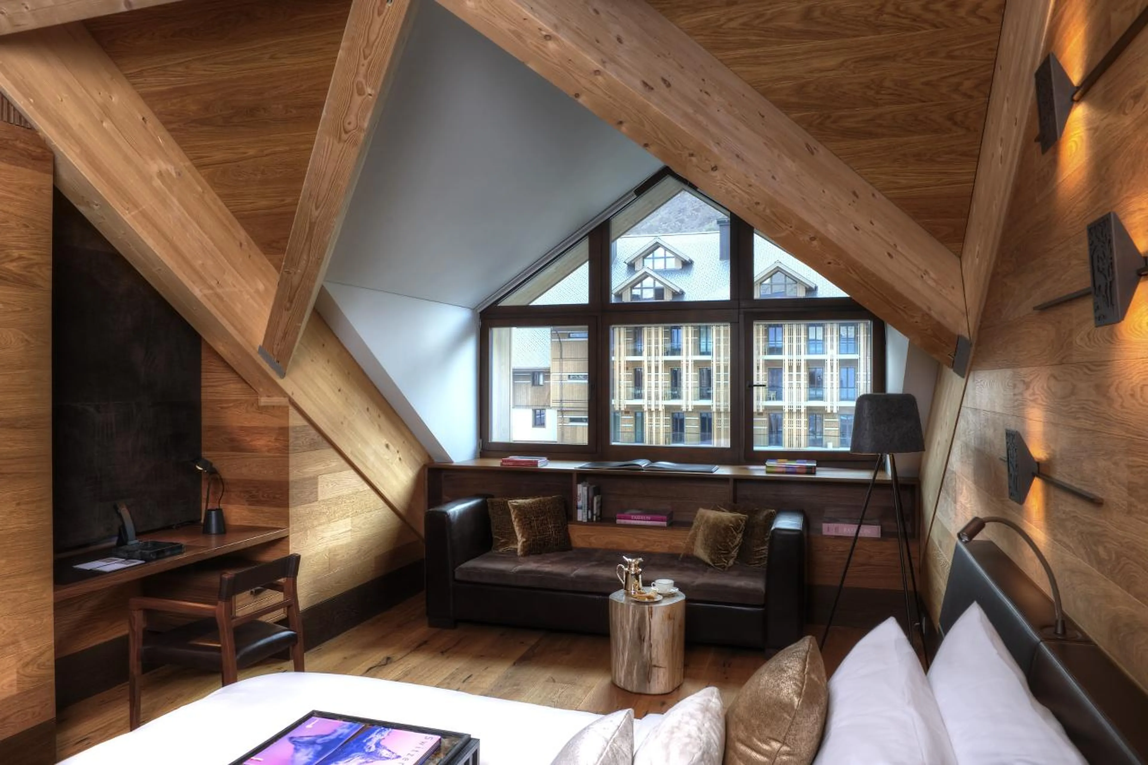 Desk and sofa in double bedroom at Furka Suite in Andermatt