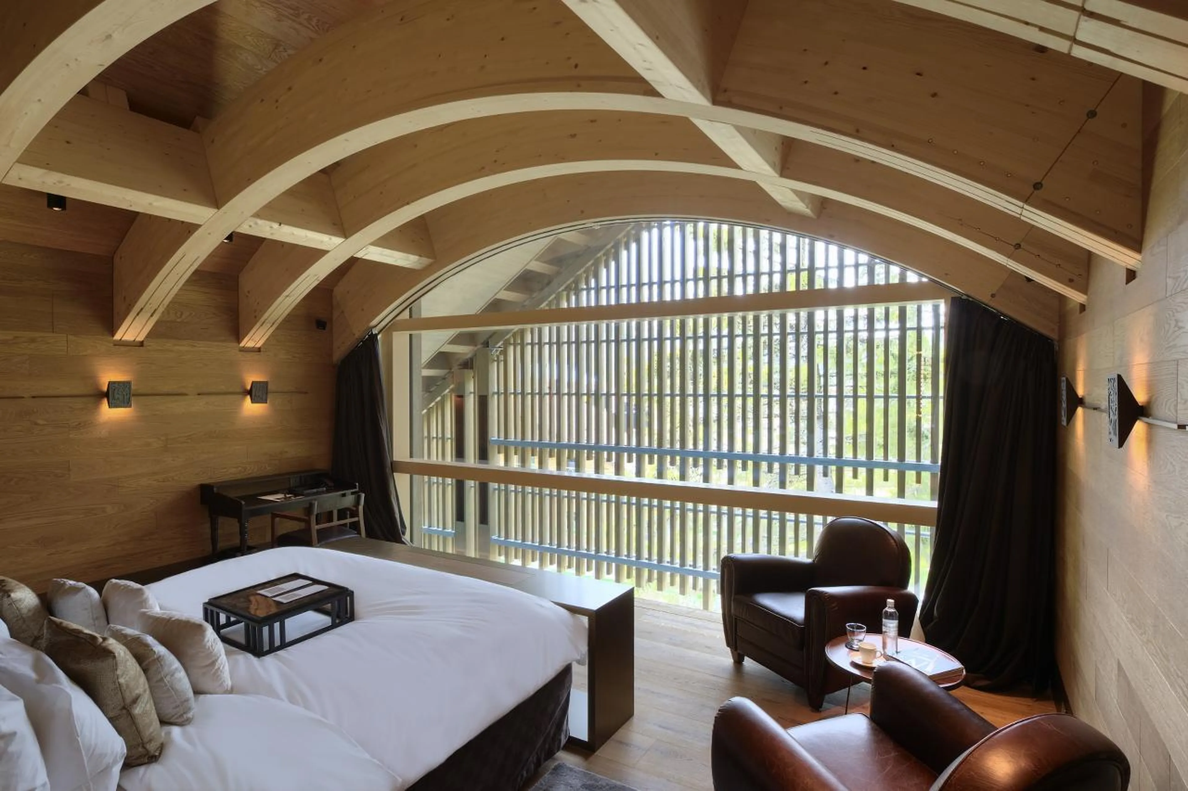 Double bed in master bedroom at Furka Suite in Andermatt