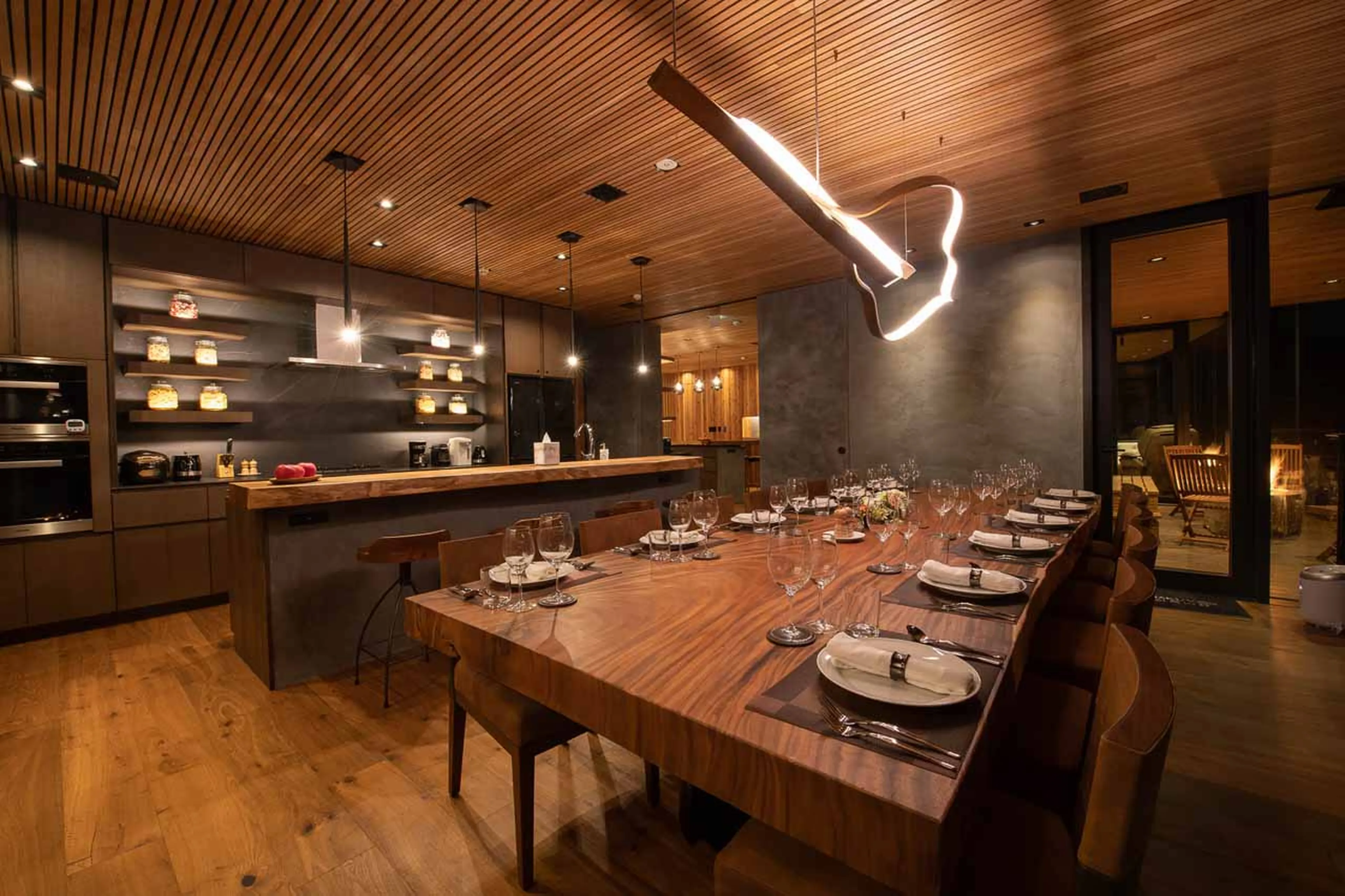 Dining room and kitchen at HakuVillas in Niseko at night