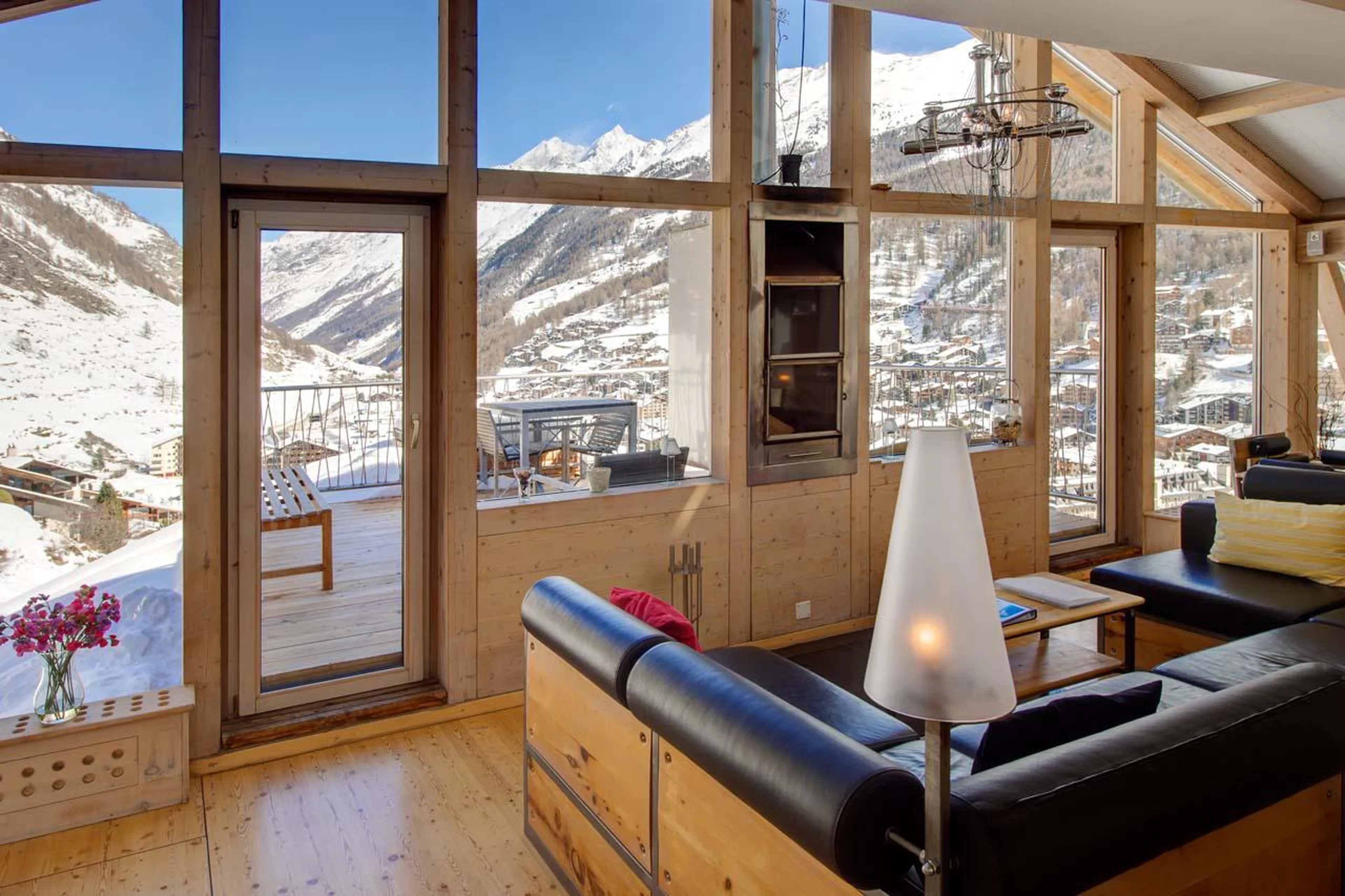Sweeping mountain views from the sofa at Heinz Julen Penthouse in Zermatt