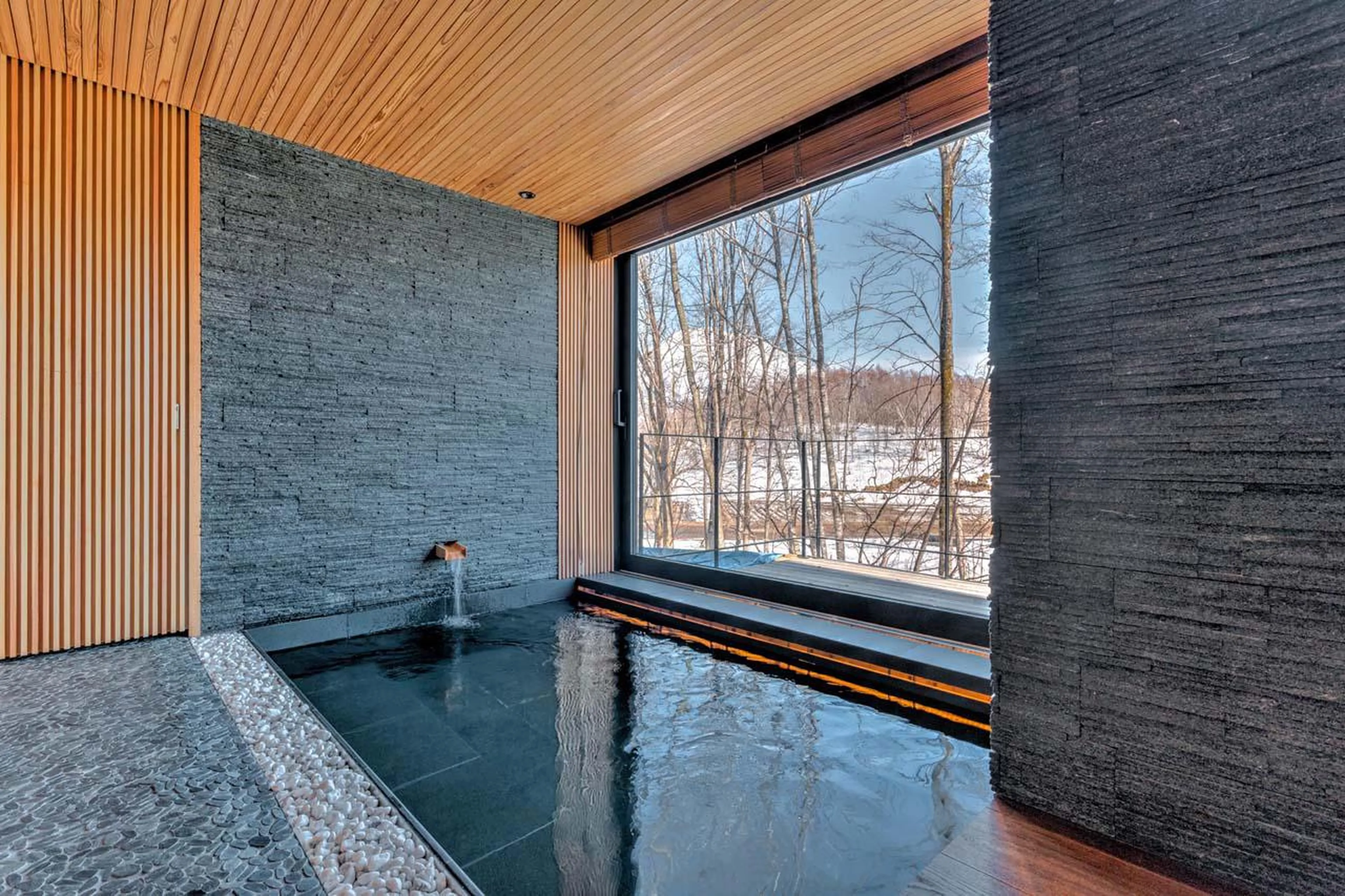 Jacuzzi overlooking forest surroundings at Hideaway on Escarpment in Niseko