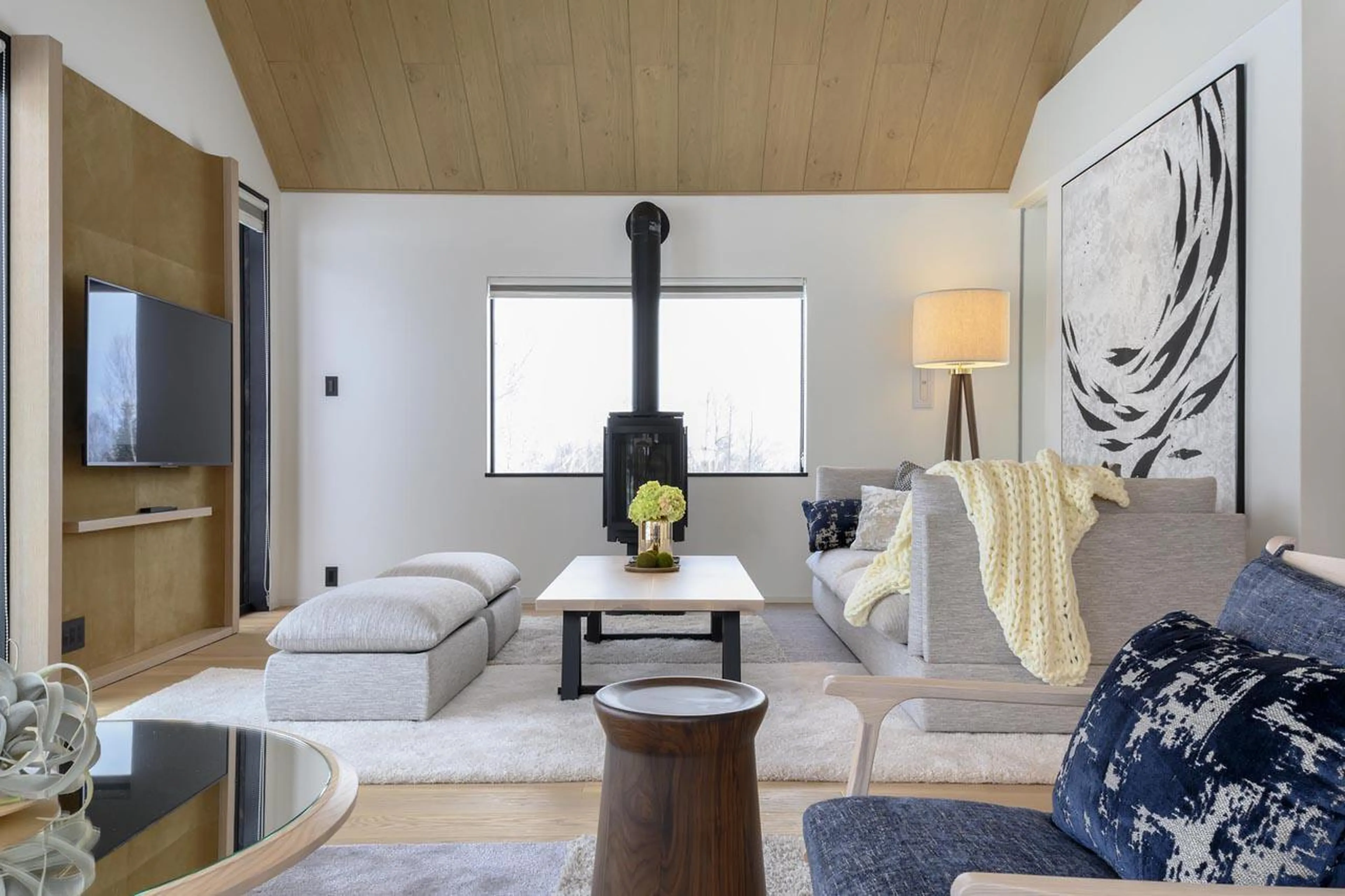 Sofa area surrounding the TV and fireplace at Koa Villa in Niseko