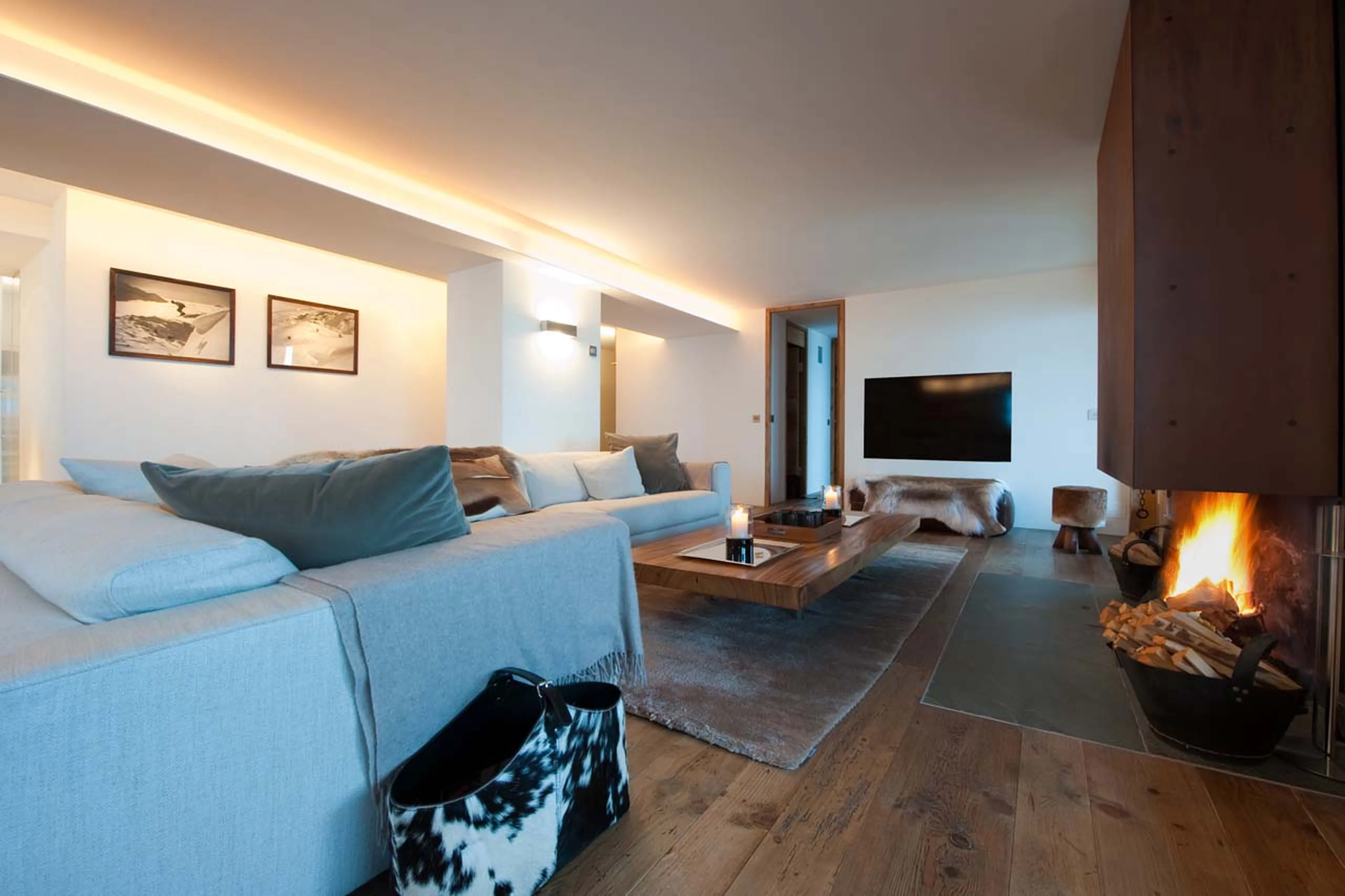 TV and fireplace in living room in La Vallée Blanche in Verbier