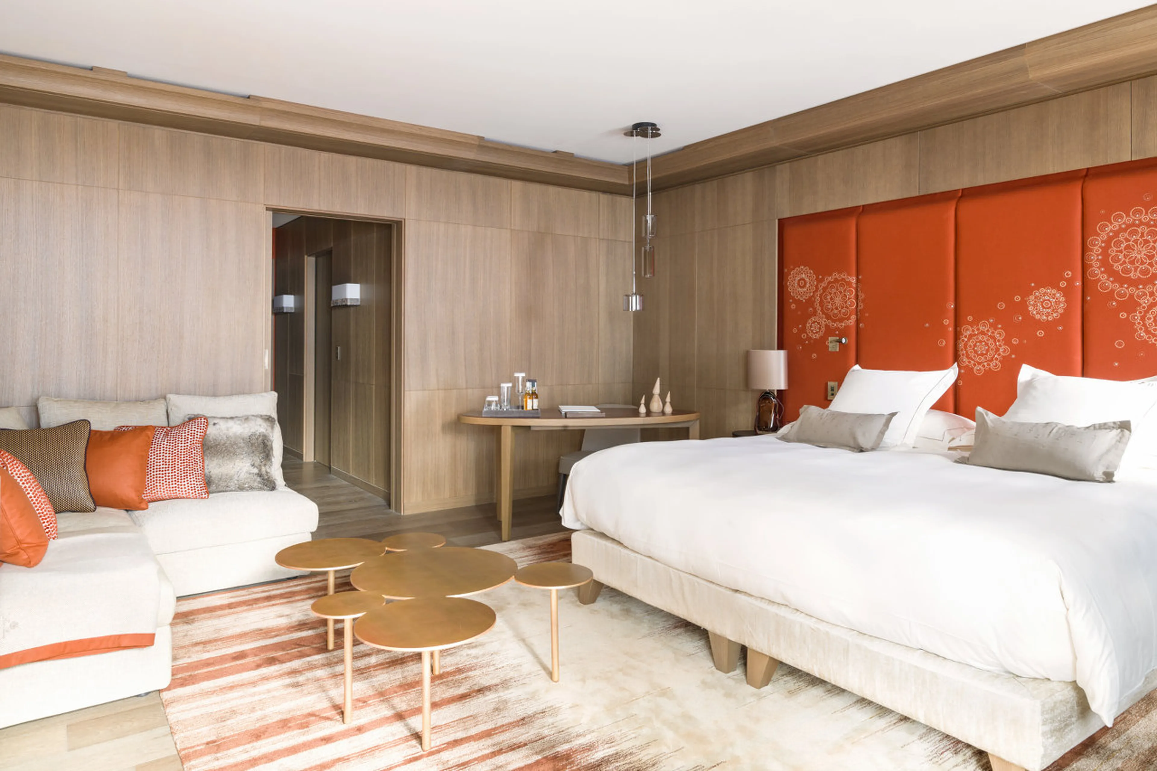 Double bedroom with lounge area and private balcony in Le Chalet Cheval Blanc in Courchevel 1850