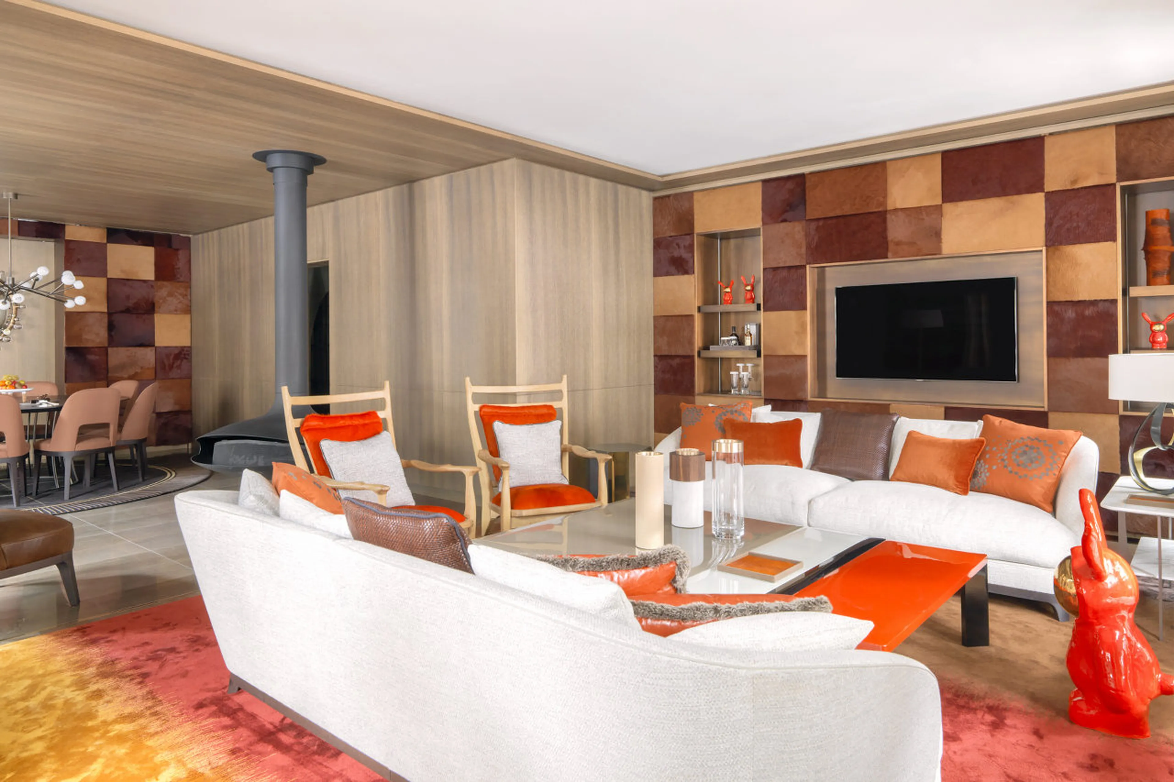 Lounge with rotating fireplace and balcony access in Le Chalet Cheval Blanc in Courchevel 1850