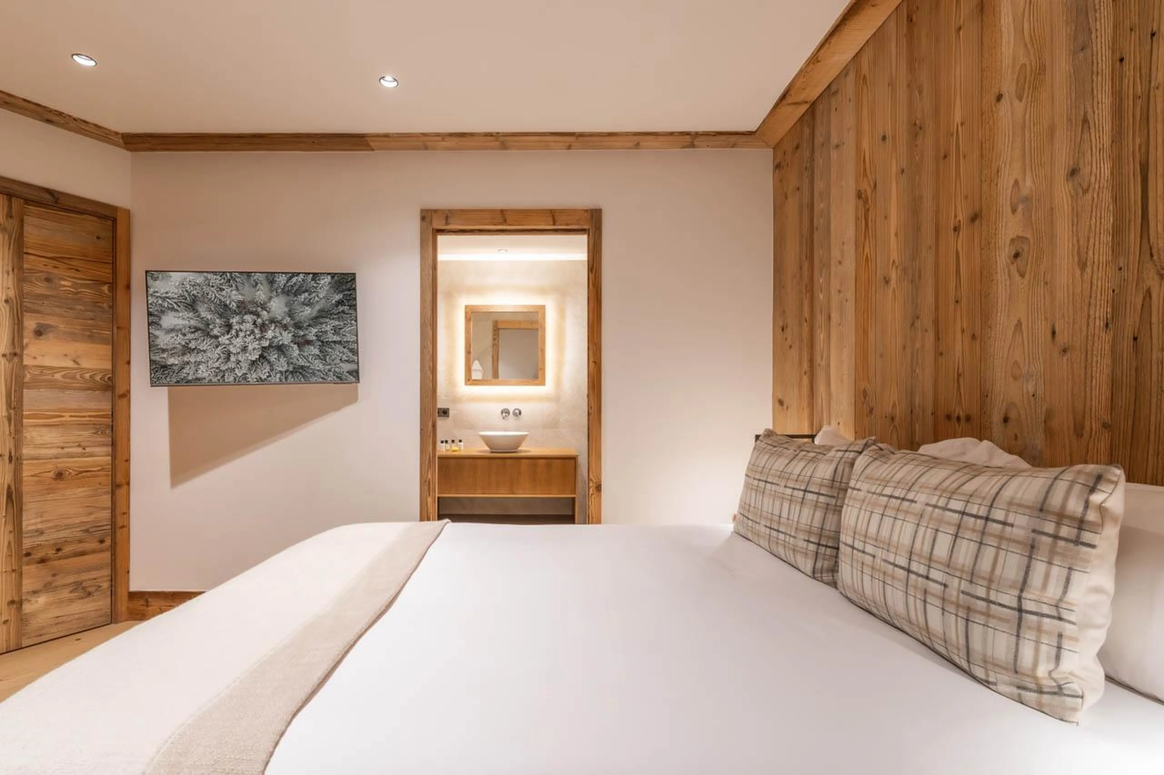 Bedroom with warm alpine aesthetics at Apartment Manej 4 in Courchevel 1850