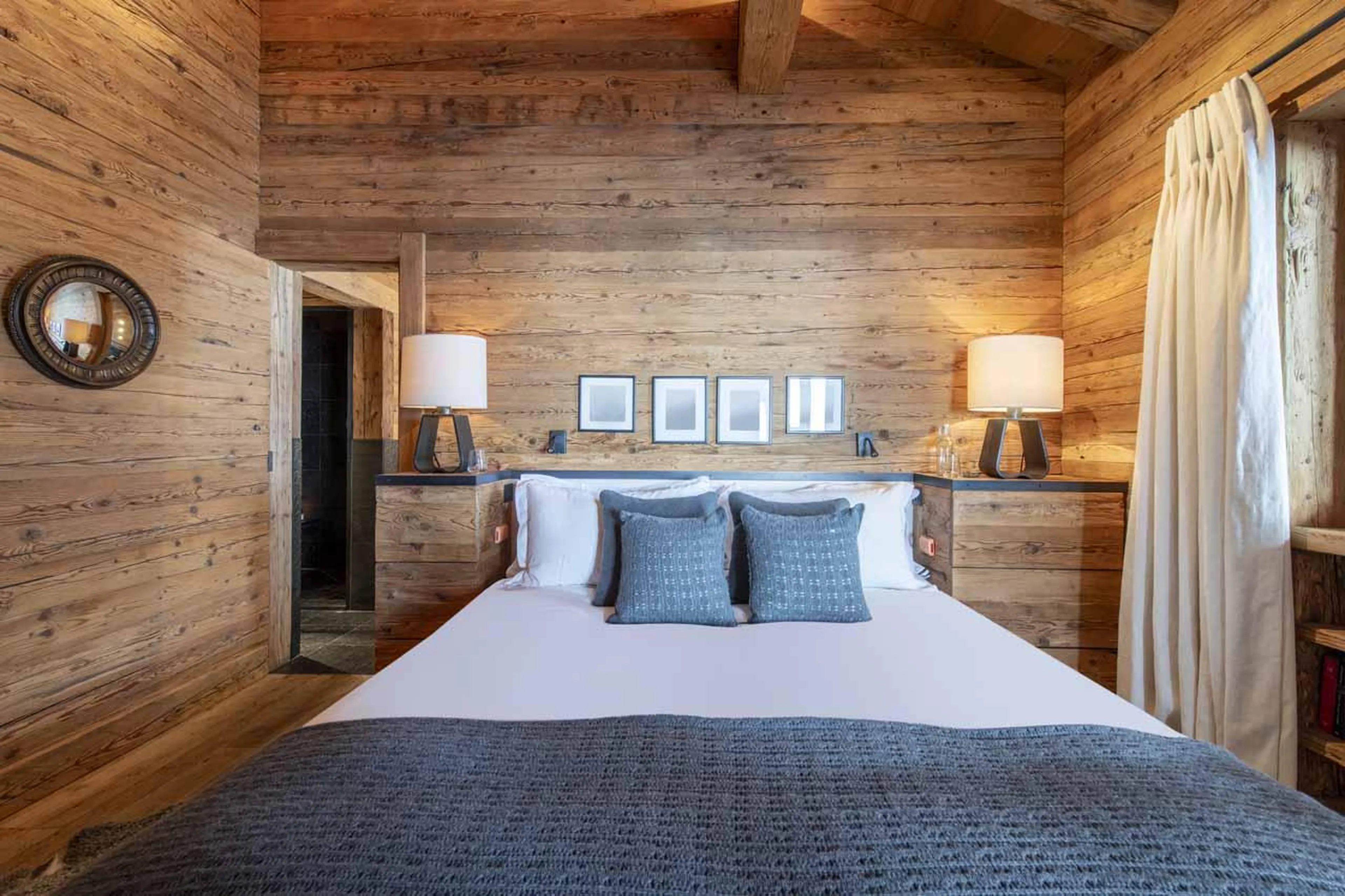 Warm double bedroom with ambient lighting at Marmotte Penthouse in Verbier