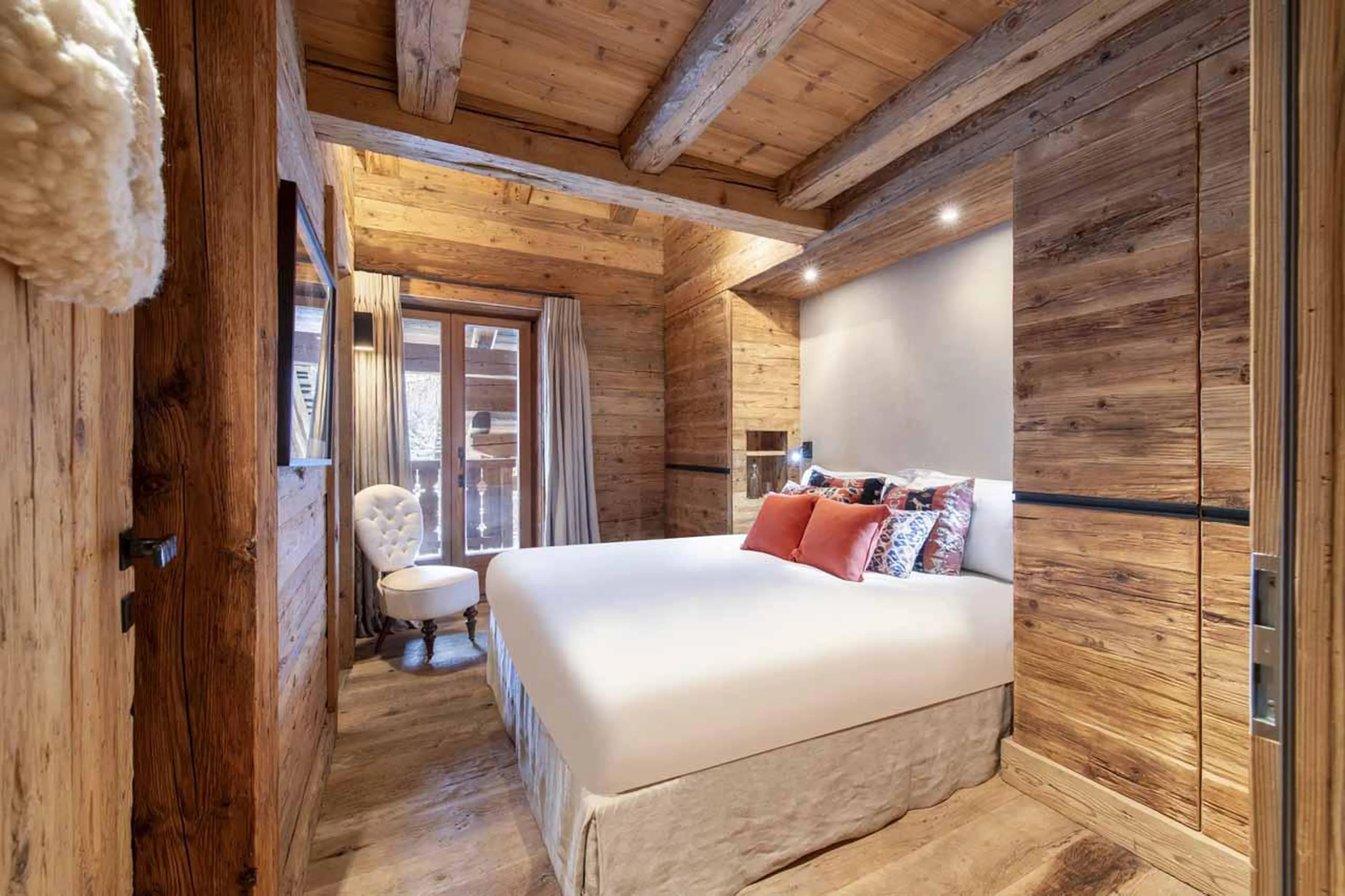 Double bedroom with en-suite shower room and balcony access at Marmotte Penthouse in Verbier