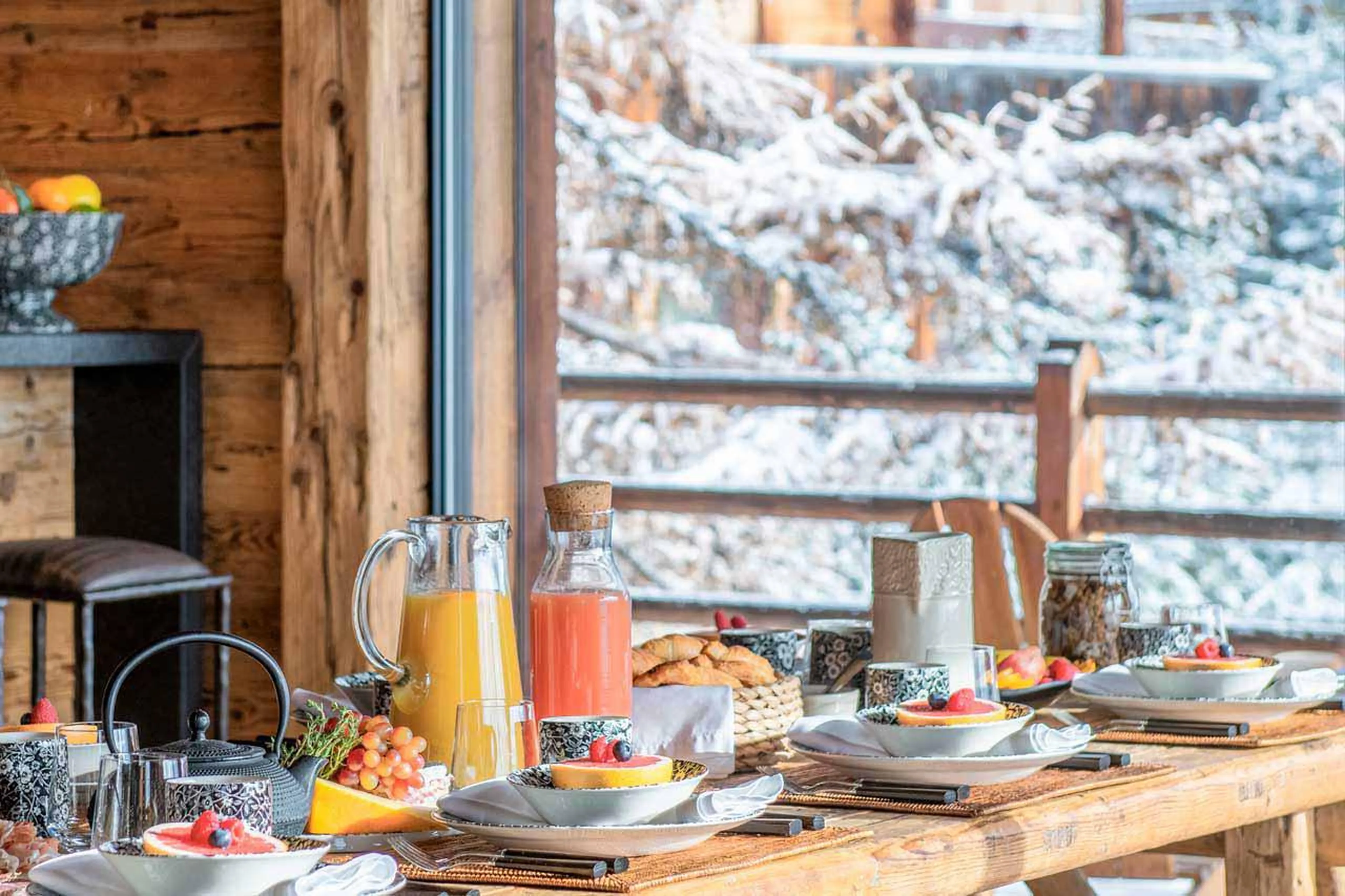 Dining table with breakfast spread at Marmotte Penthouse in Verbier