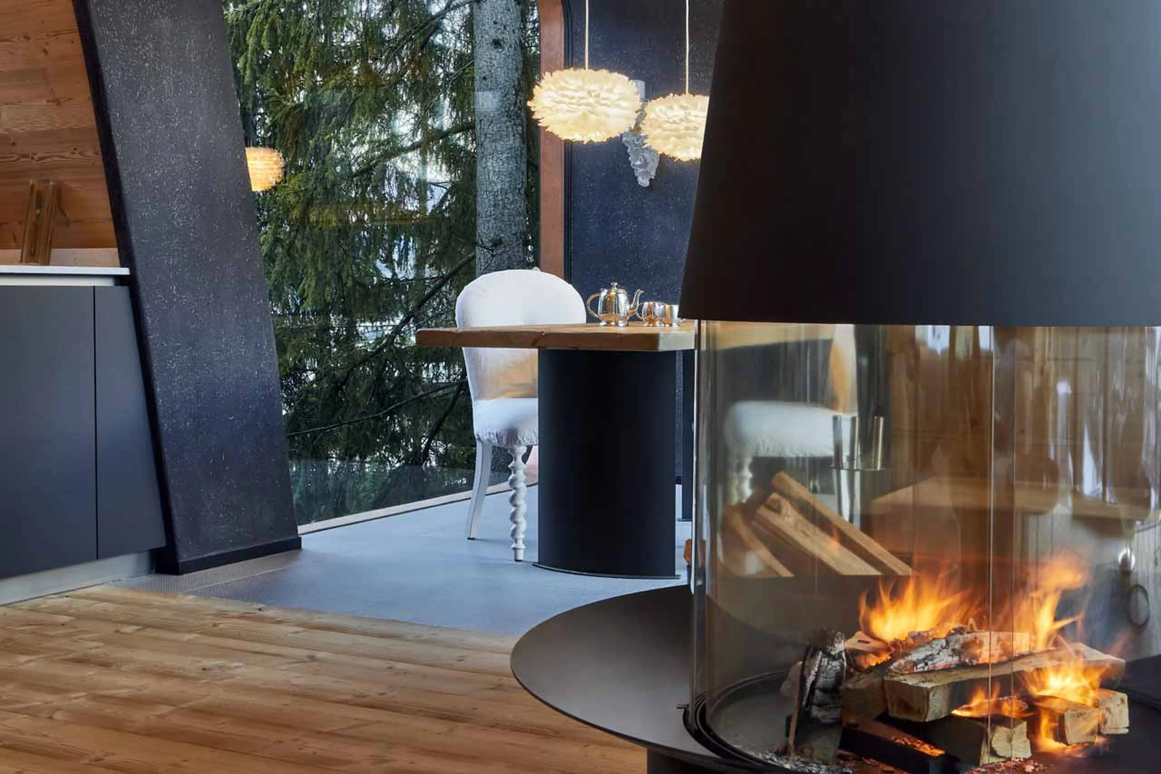 Feature fireplace and dining area at Mi Chalet in Alta Badia