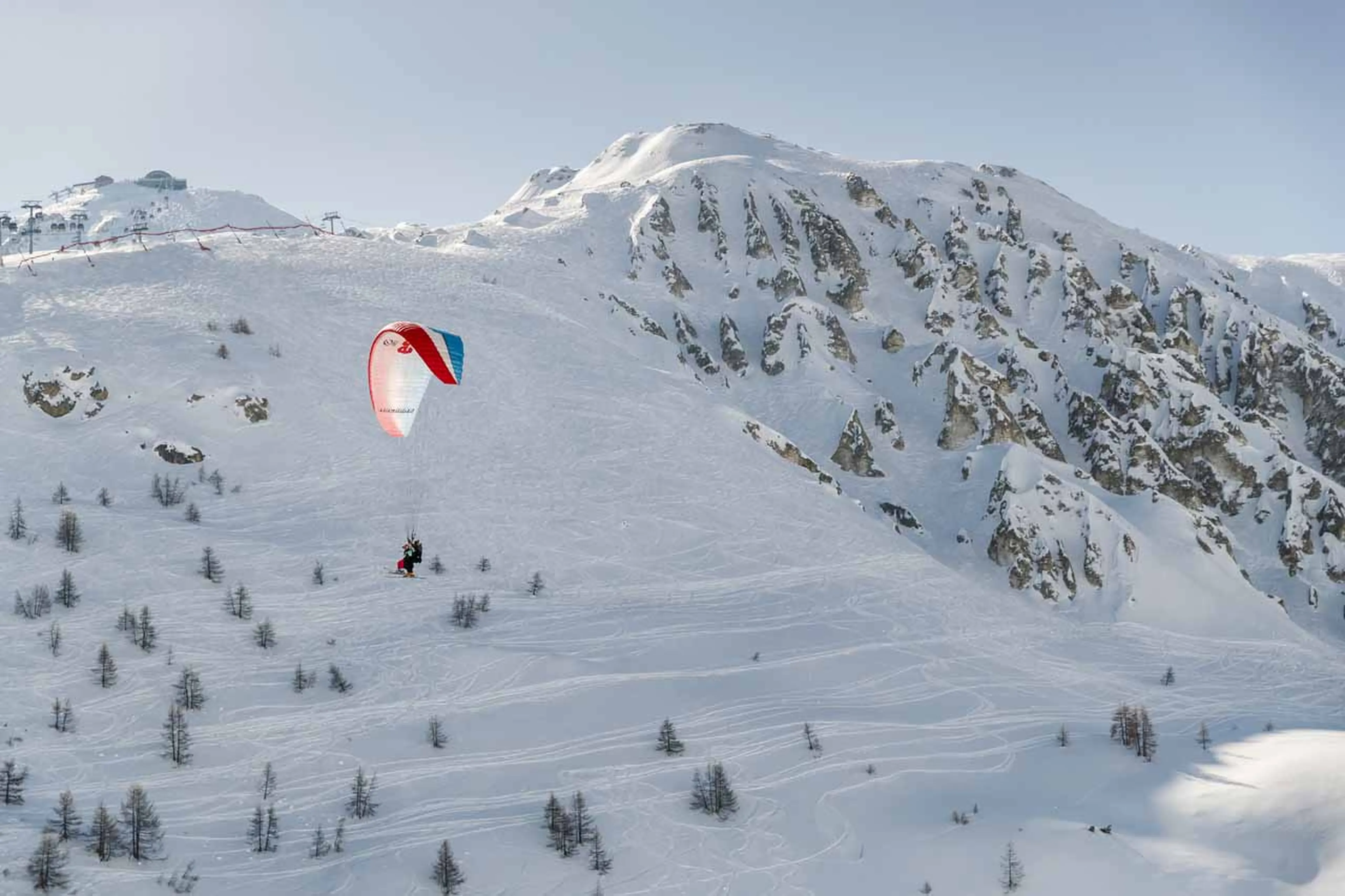 Paragliding over mountains in Tignes