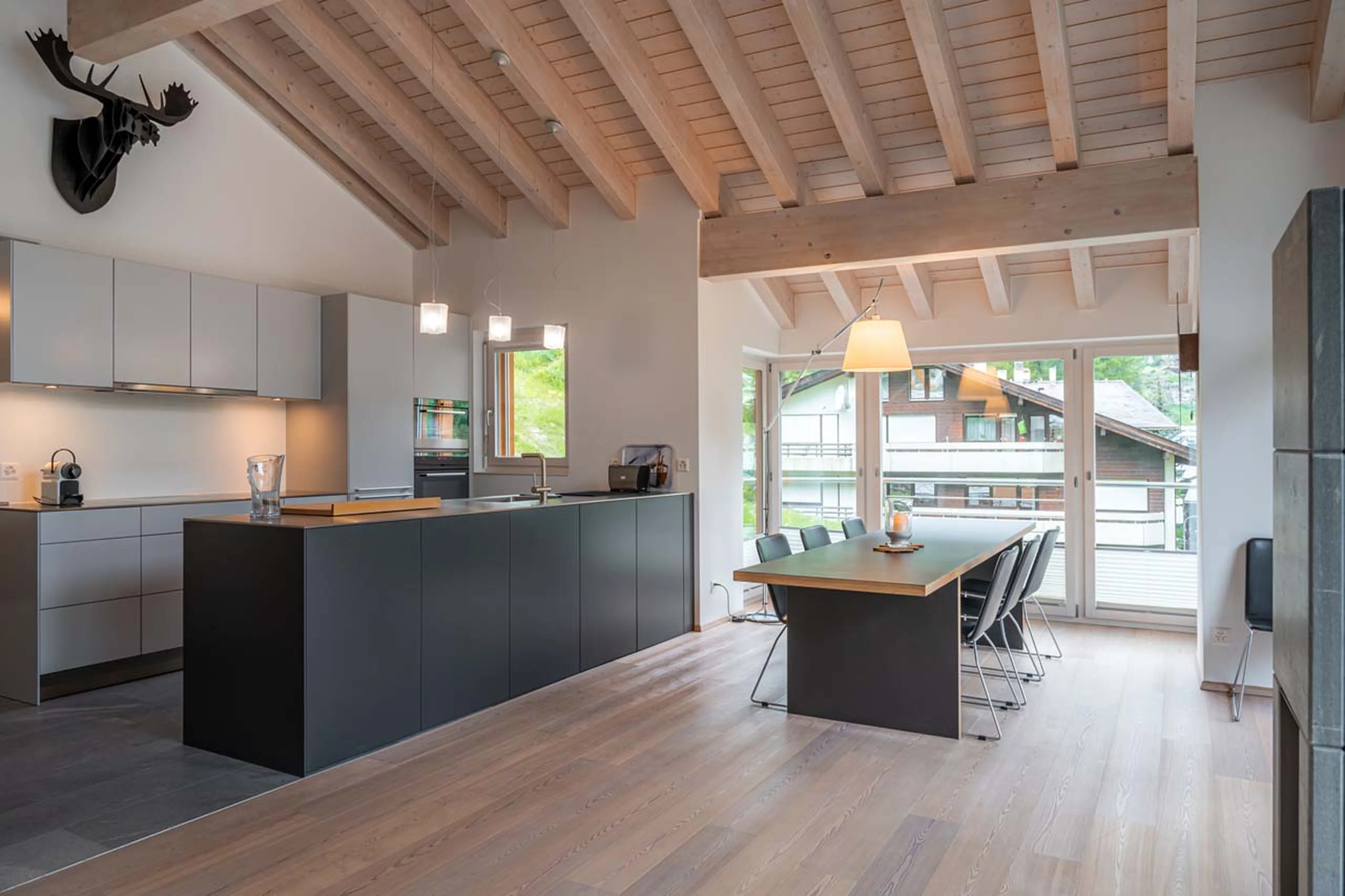 Open plan kitchen and dining area at Parrot Penthouse in Zermatt