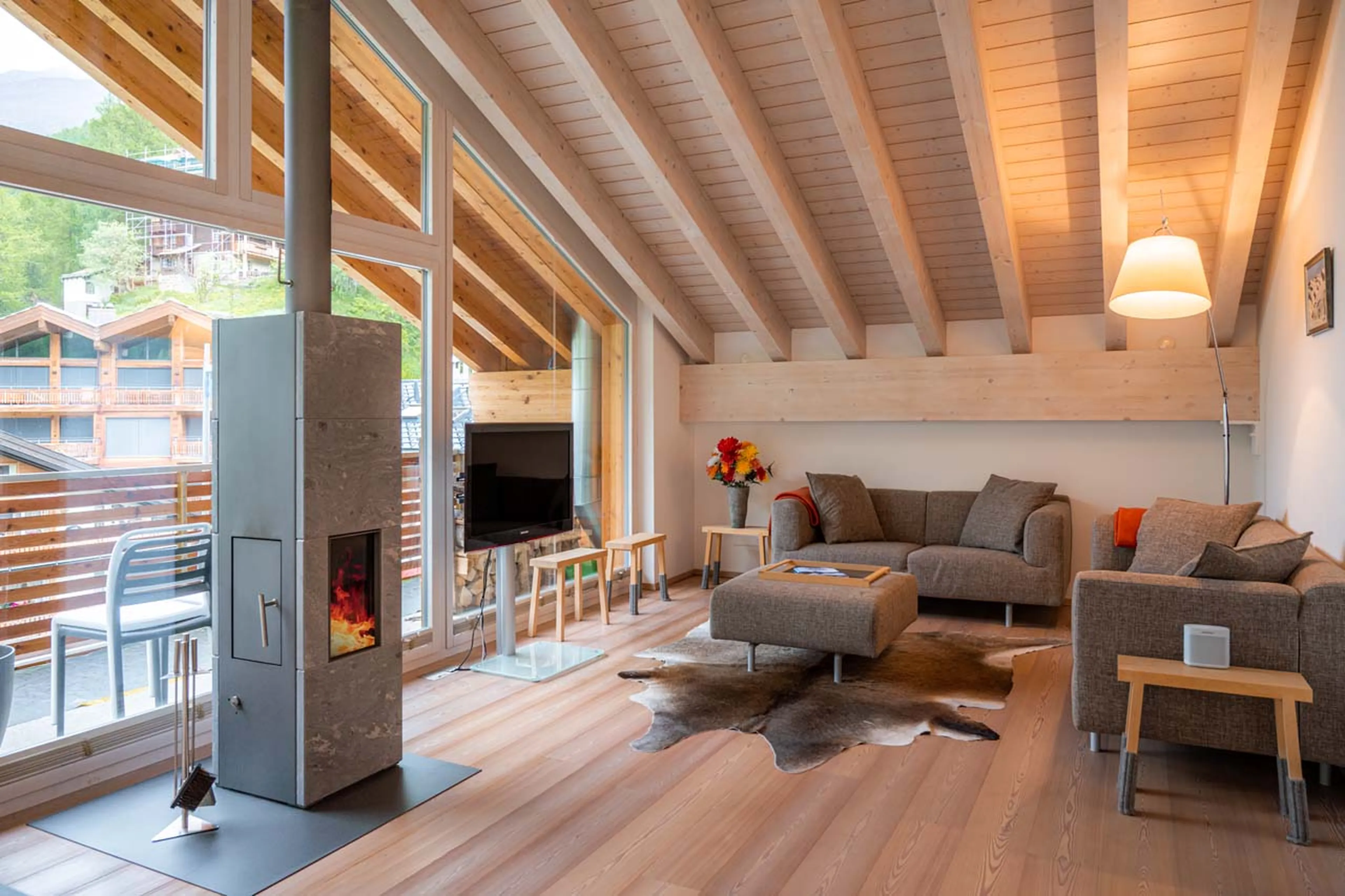 Wood-burning fireplace in living area of Parrot Penthouse in Zermatt