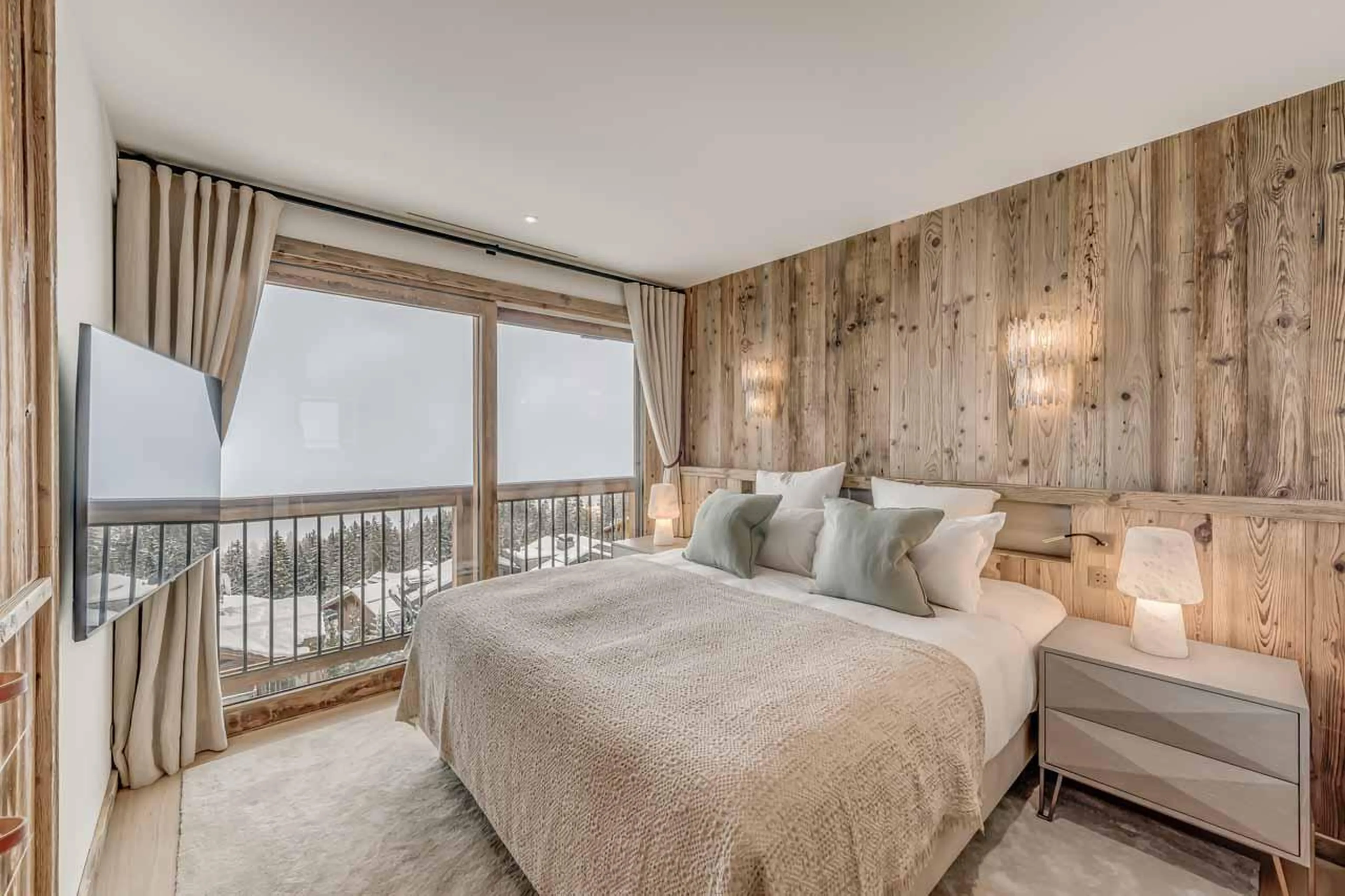 Double bedroom with stunning mountain views, and ensuite bathroom at Penthouse B in Courchevel 1850