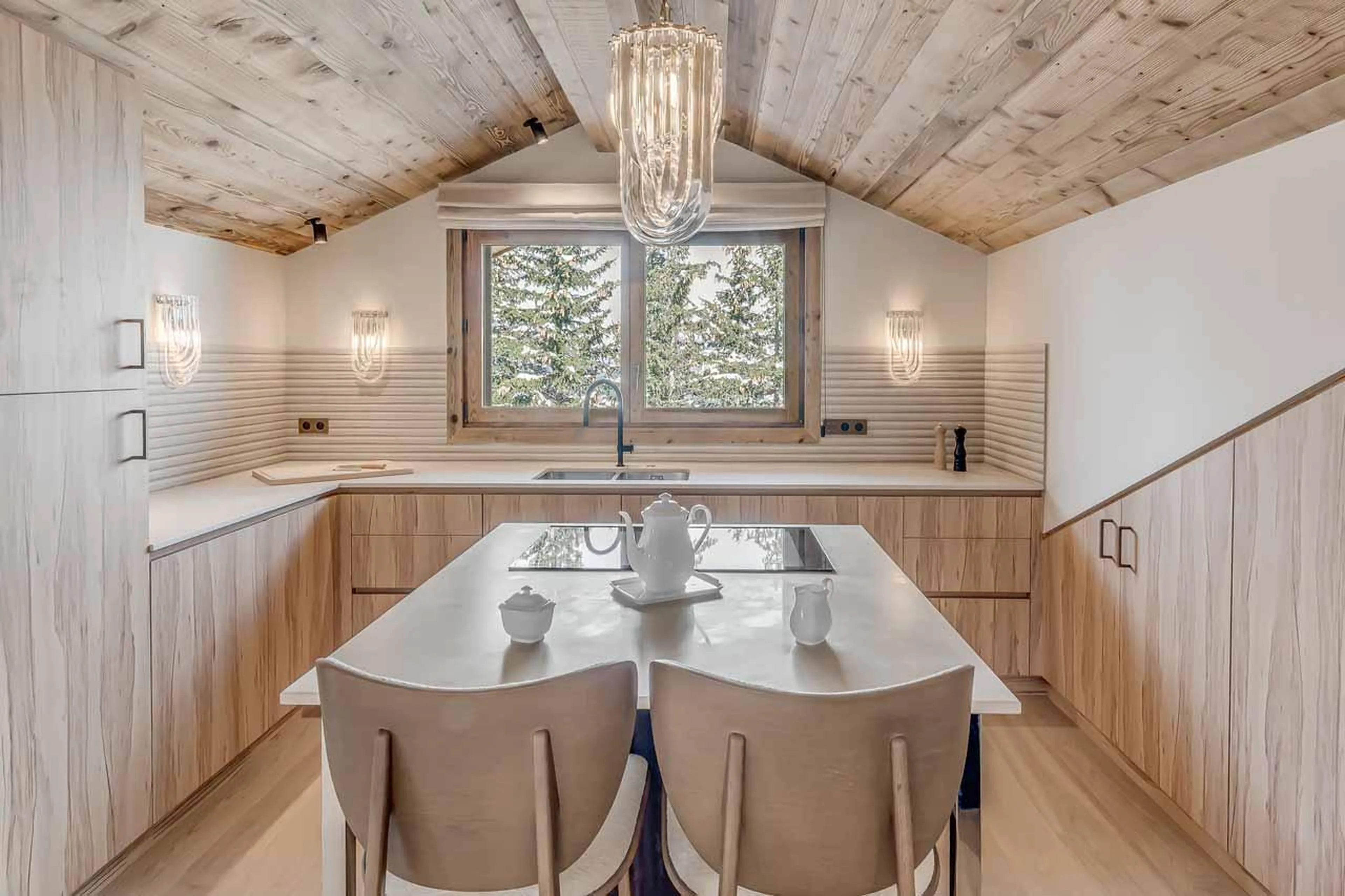 Bright kitchen area with bar stools and wine fridge at Penthouse B in Courchevel 1850