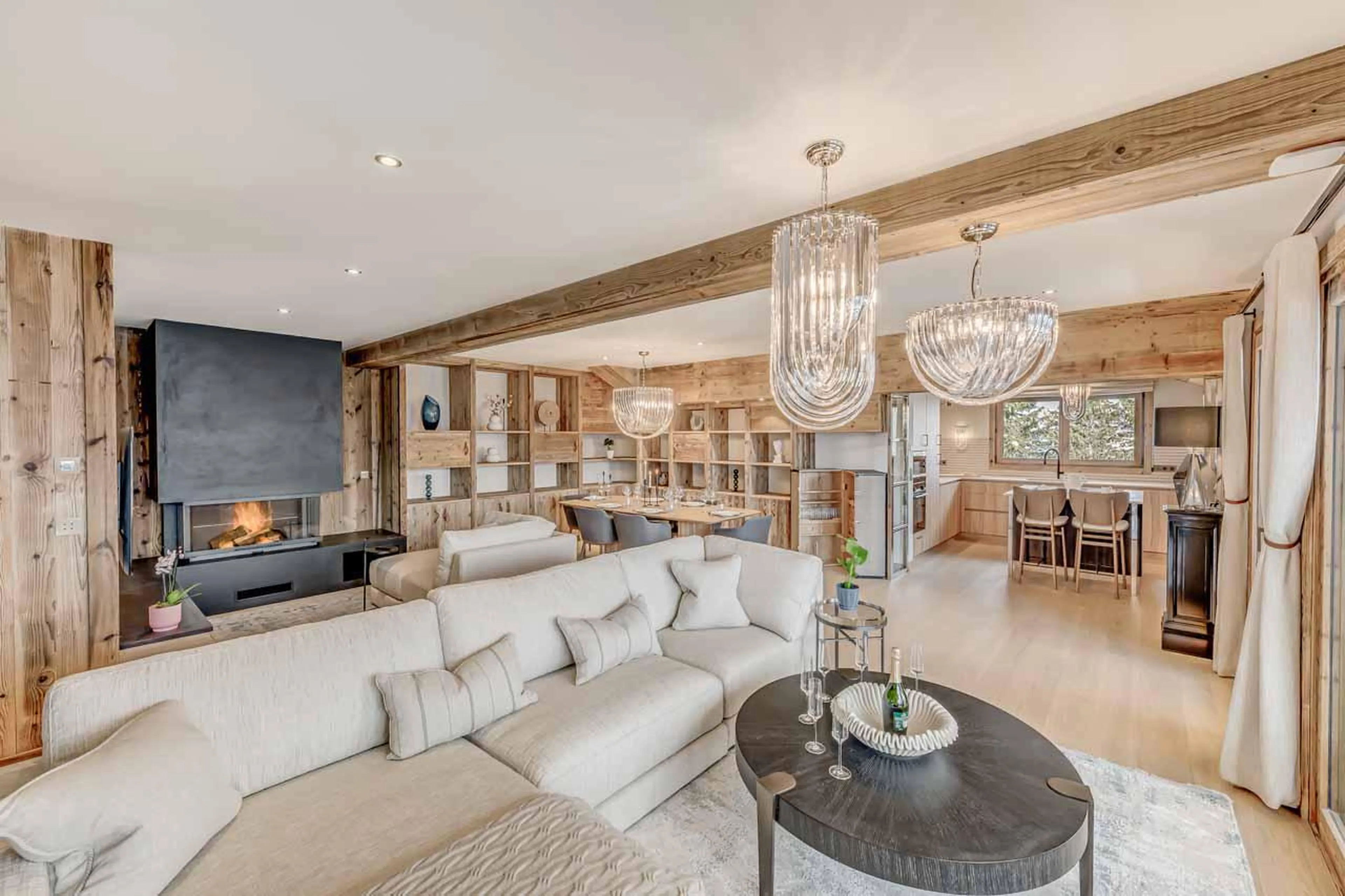 Spacious living area with open fire at Penthouse B in Courchevel 1850