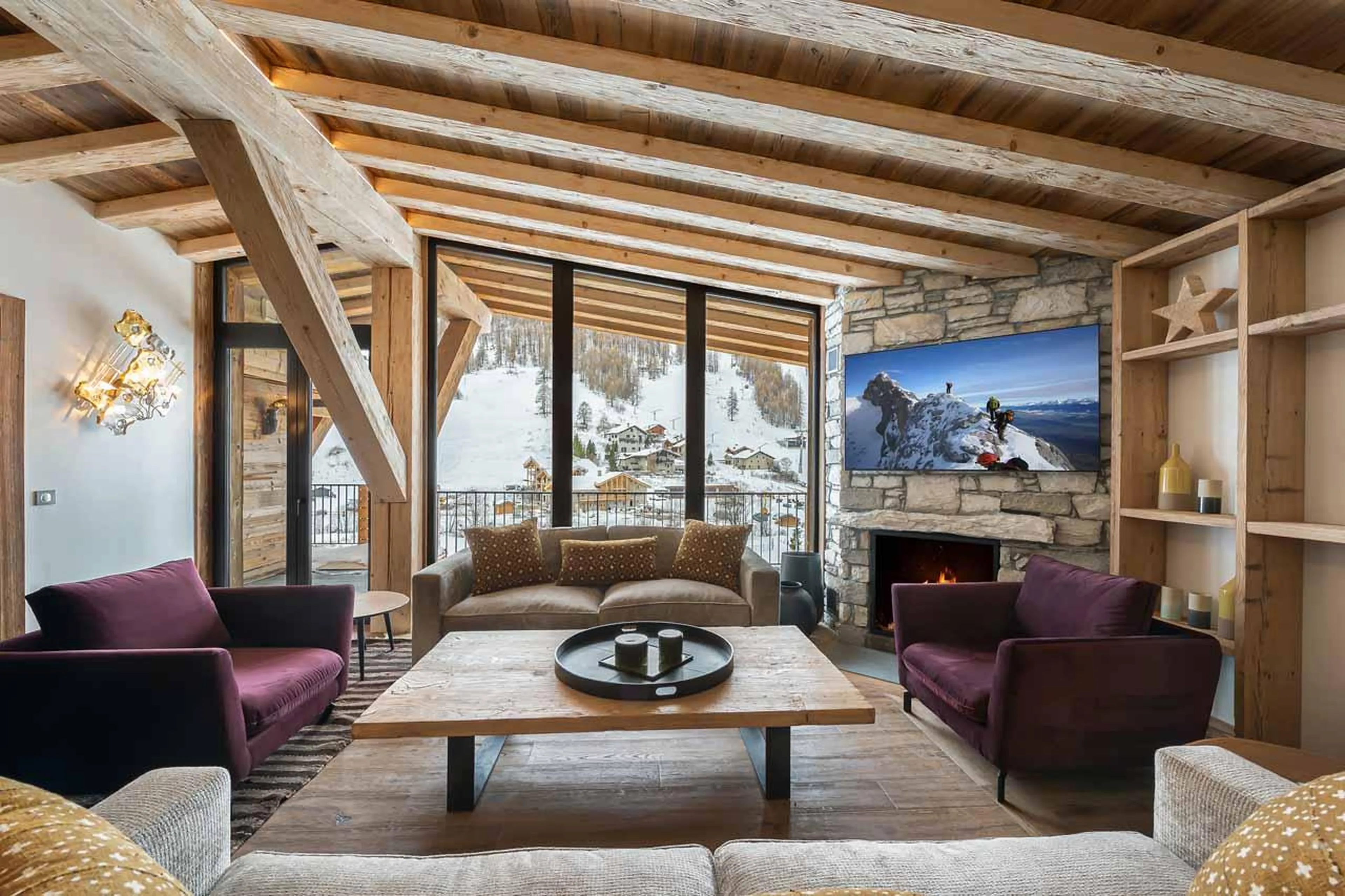 Comfortable sofas arranged around cosy fireplace in Penthouse Fleche, Val d'Isere