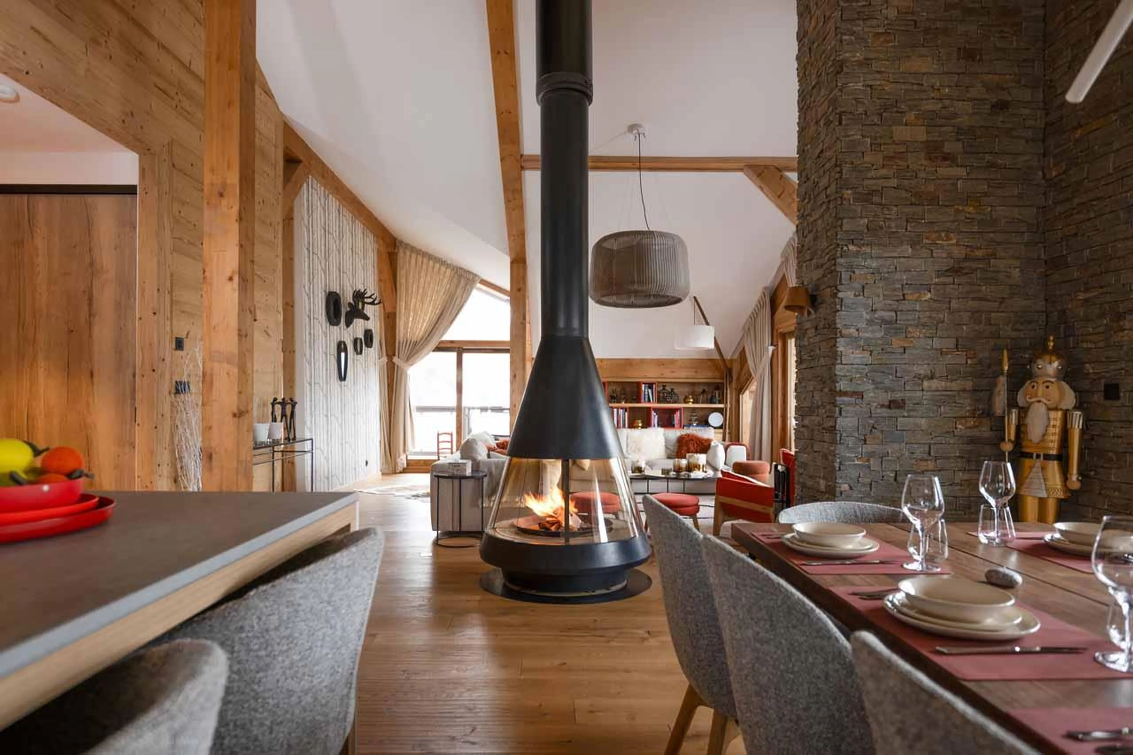 Open-plan living area with wood-burning fireplace at Penthouse Le Belladone in Courchevel 1650