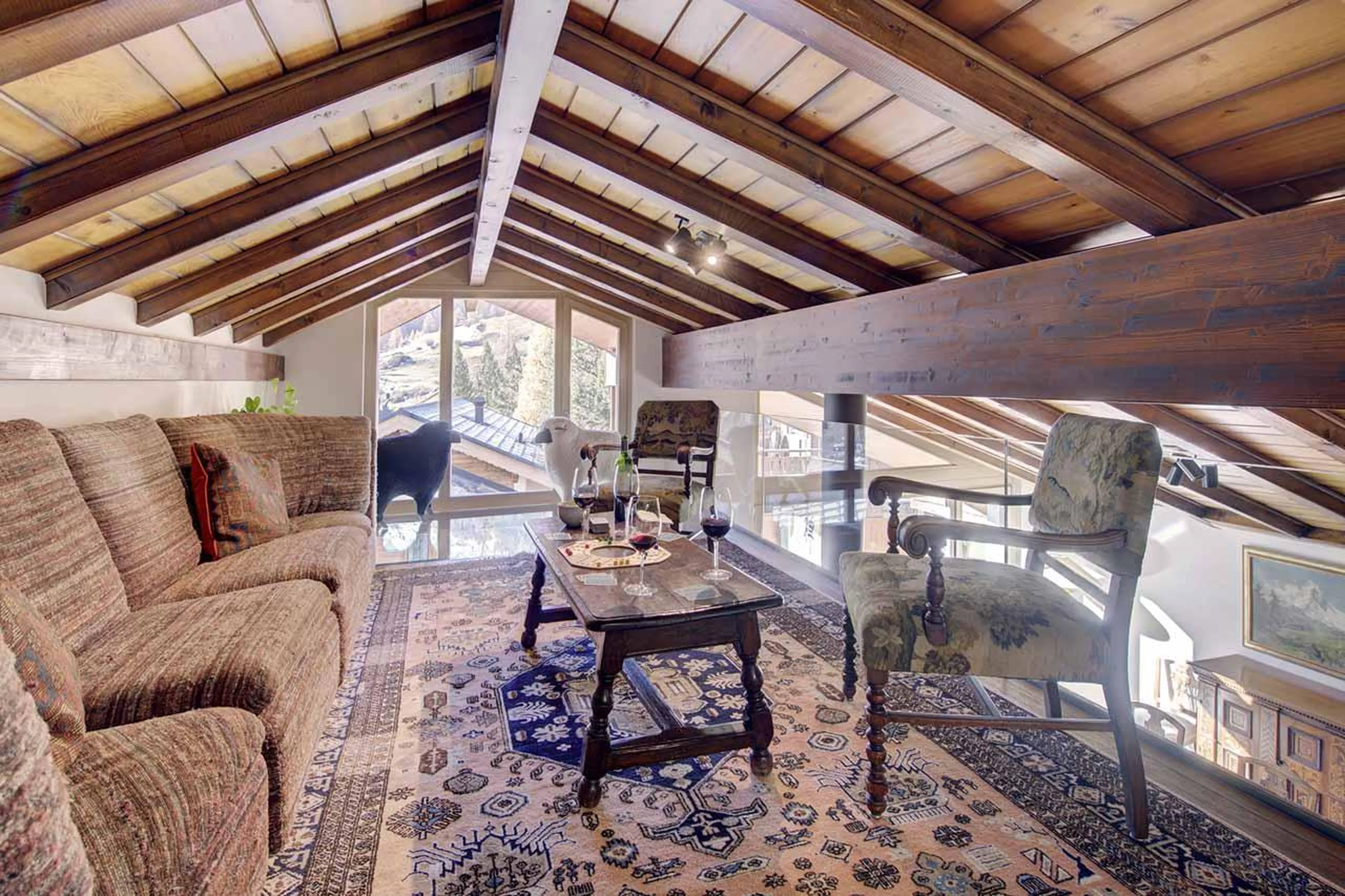 Cosy upper gallery with comfortable seating at Penthouse Zen in Zermatt