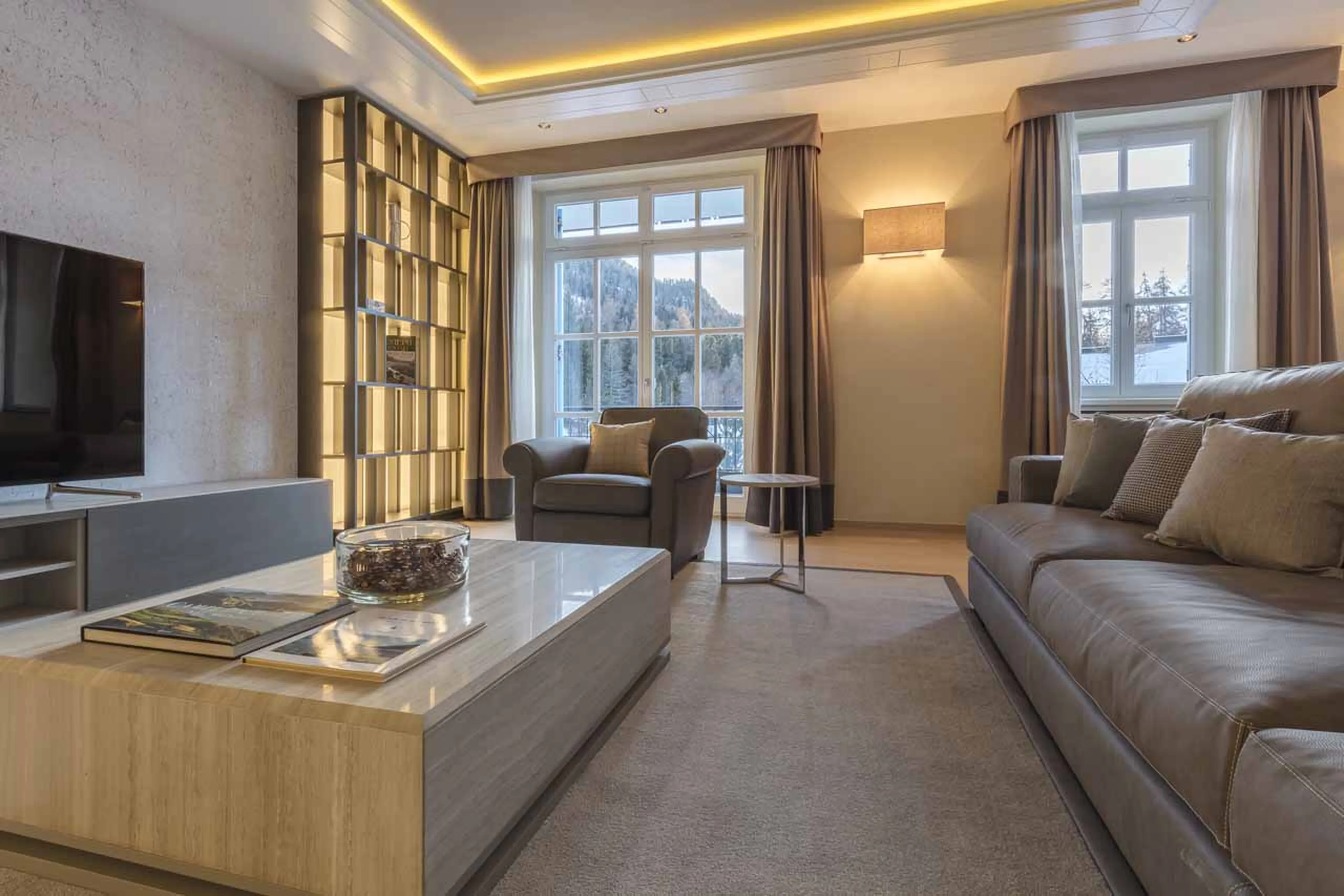 Sofas and TV in living area at Piz Mandra in St Moritz