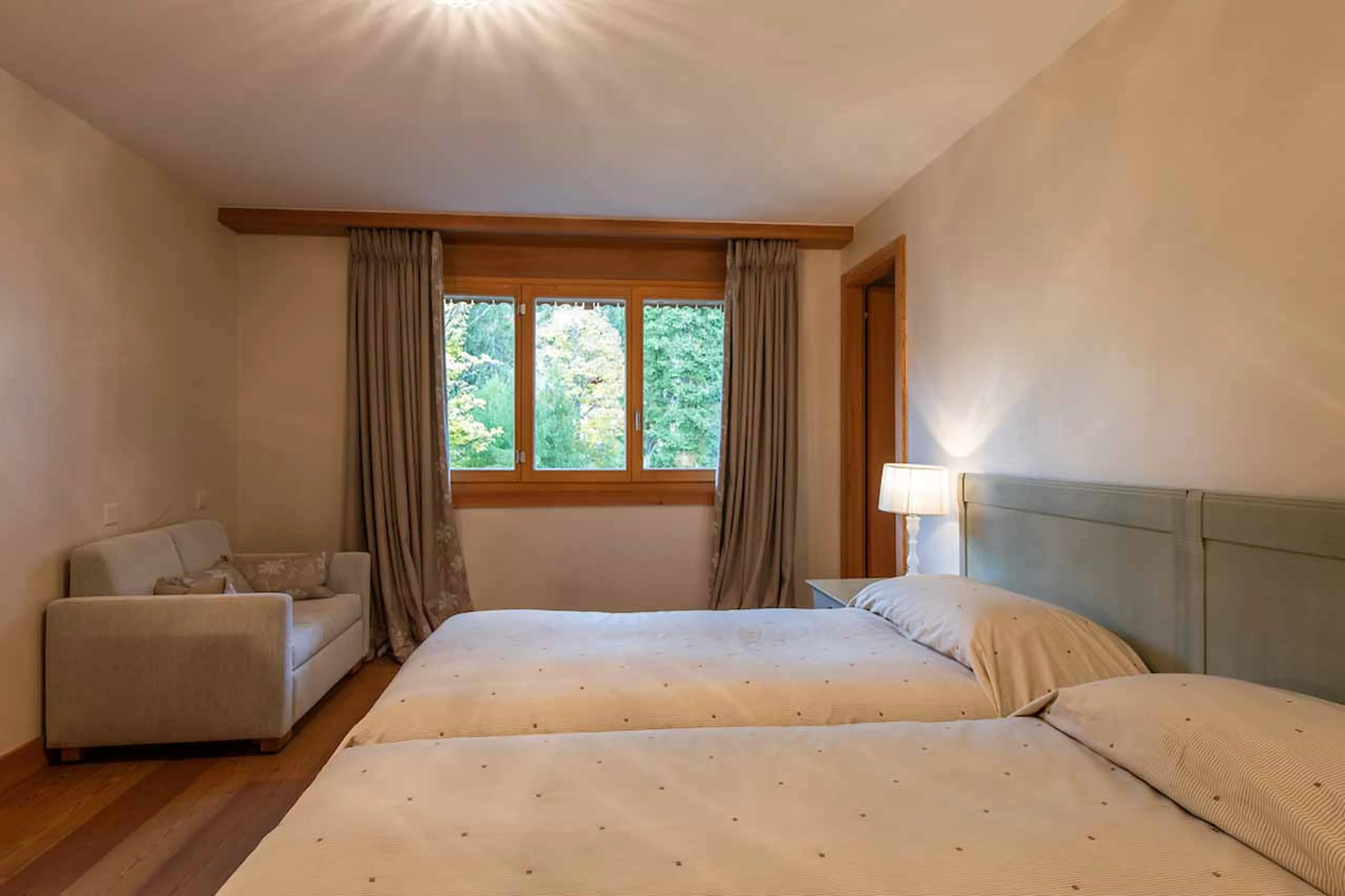 Sofa in twin bedroom at Royalp Modern Penthouse in Villars