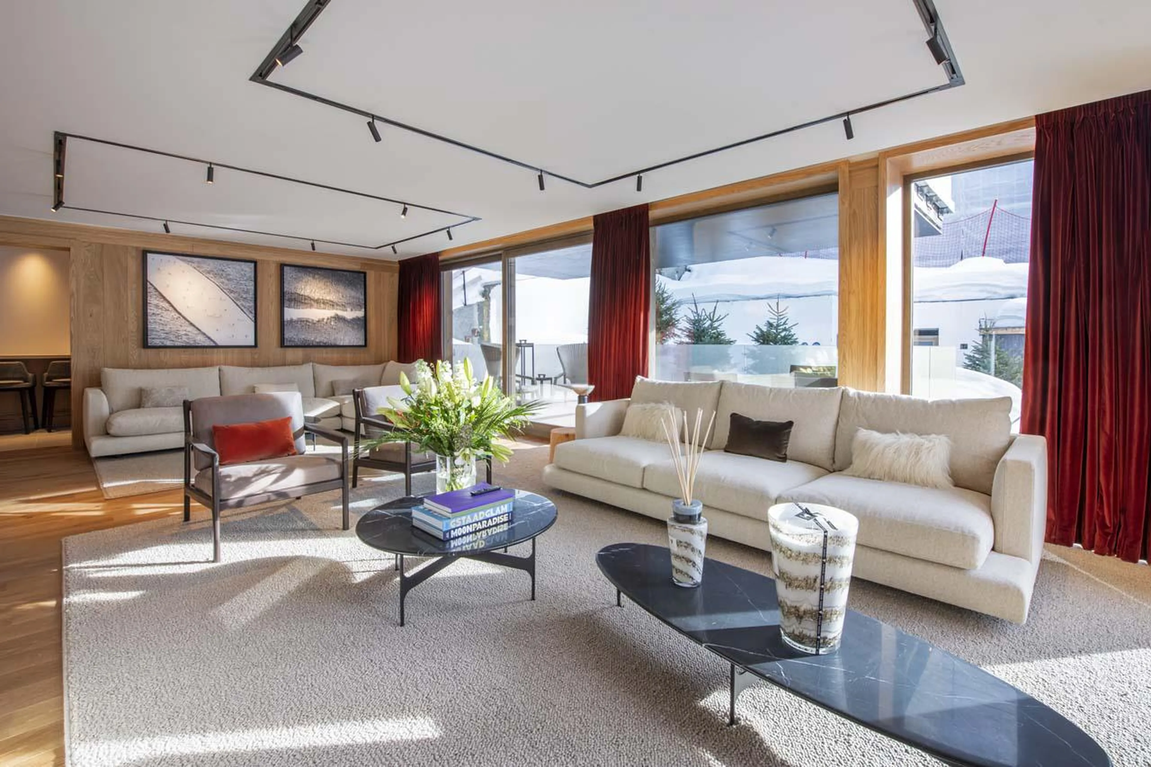 Expansive sofas and floor-to-ceiling windows at Sasha Apartment 4 in Courchevel 1850