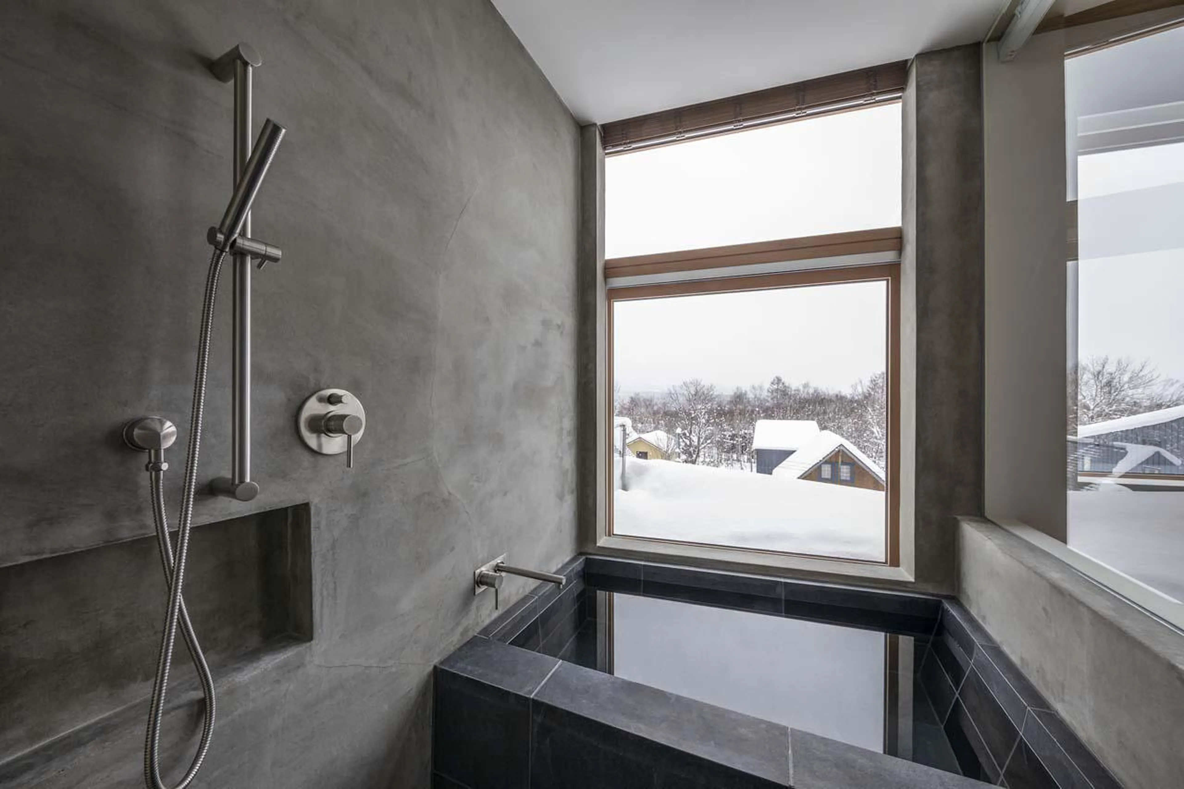 En-suite bathroom with snowy views at Silver Dream in Niseko