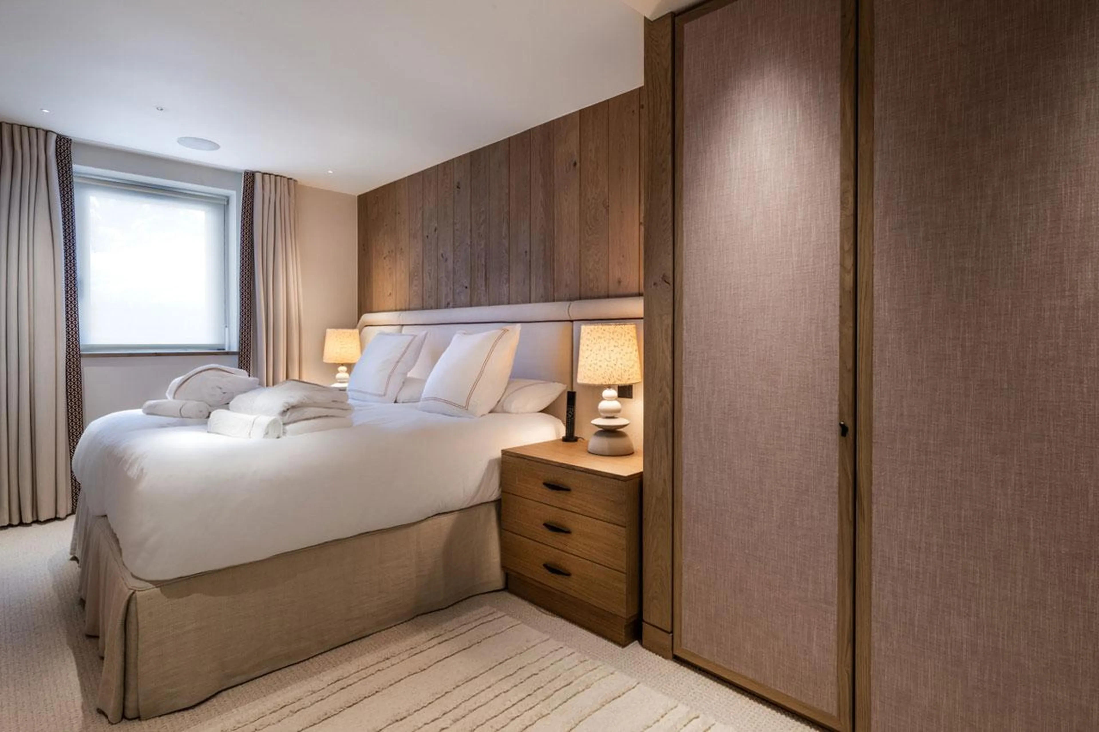 Double bedroom with king-sized bed at Silverstone Lodge Penthouse 4 in Val d'Isere