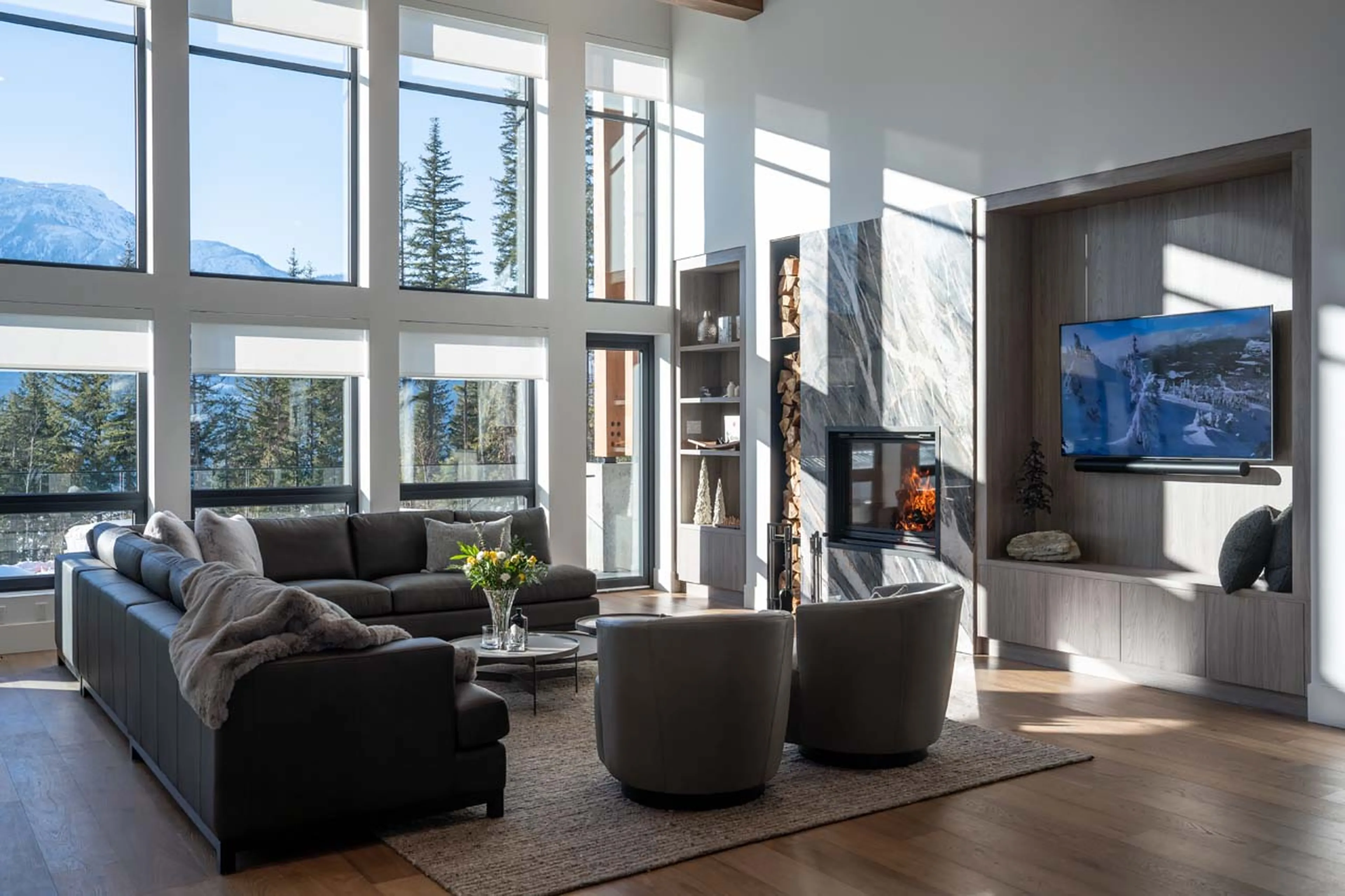 Sitting area with fireplace and TV in Sitka Spruce Mountain, Revelstoke