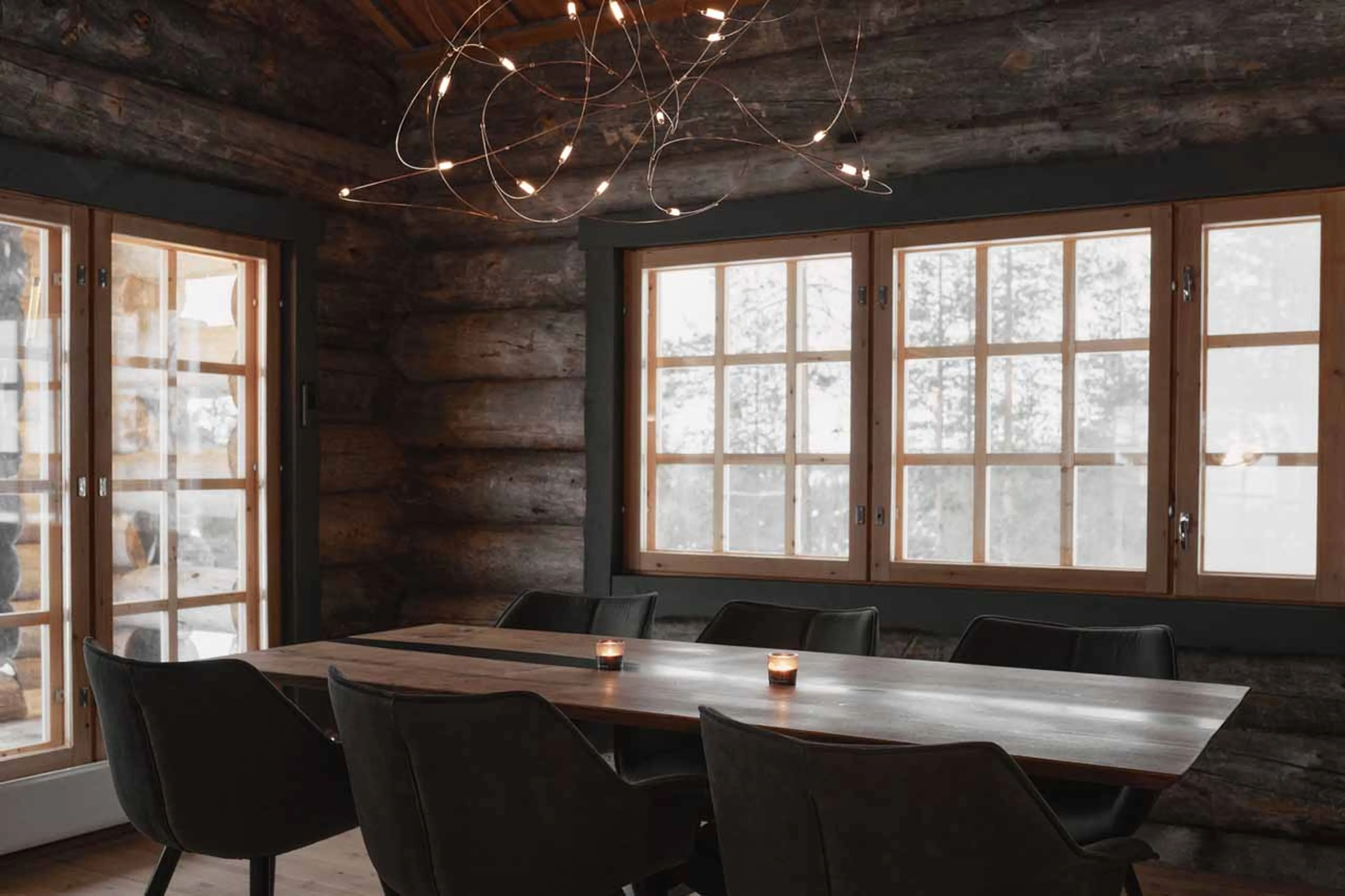 Dining table with contemporary lighting in The Fell Lodge, Finland