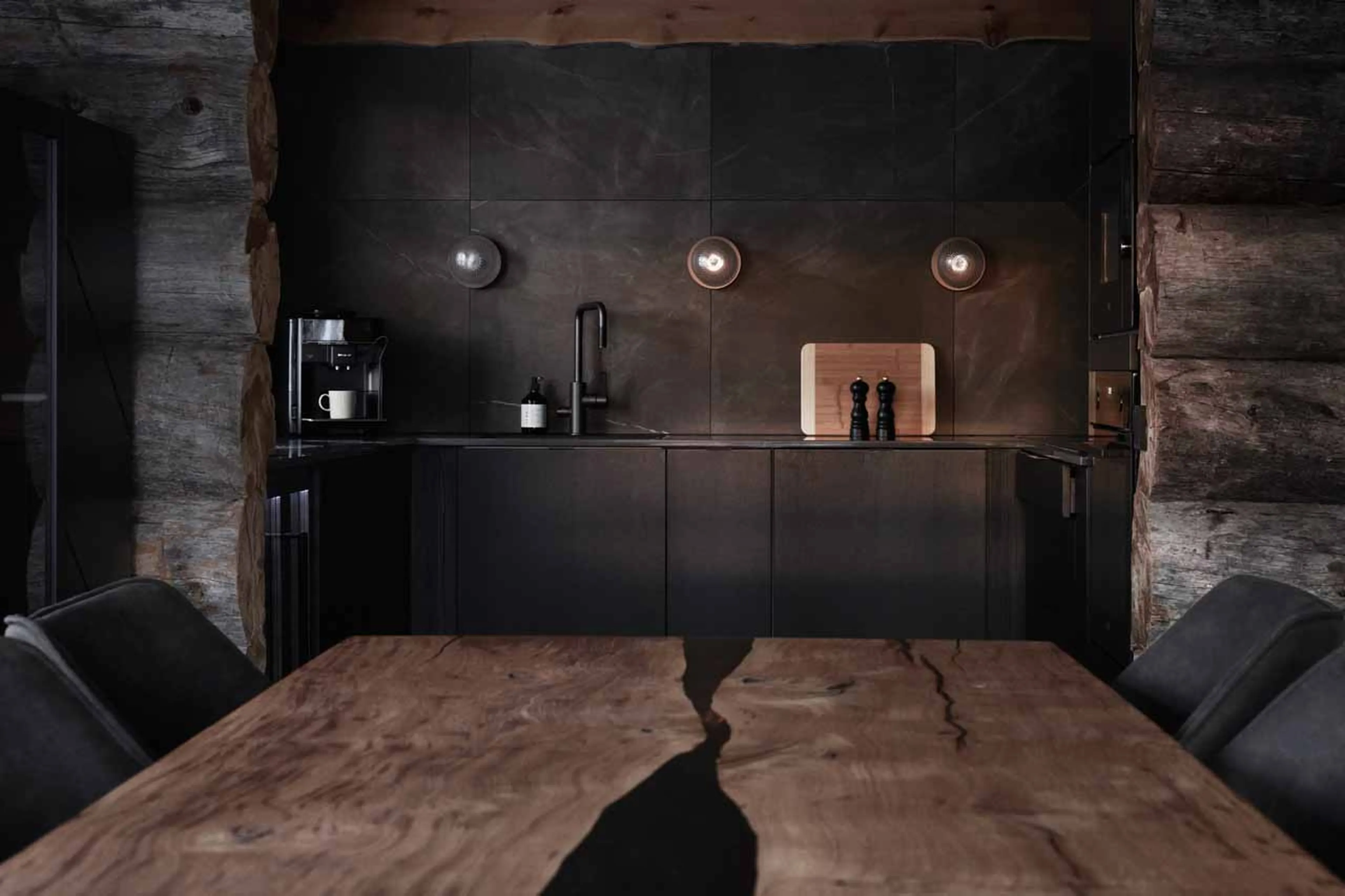 Dining table and kitchen in The Fell Lodge, Finland