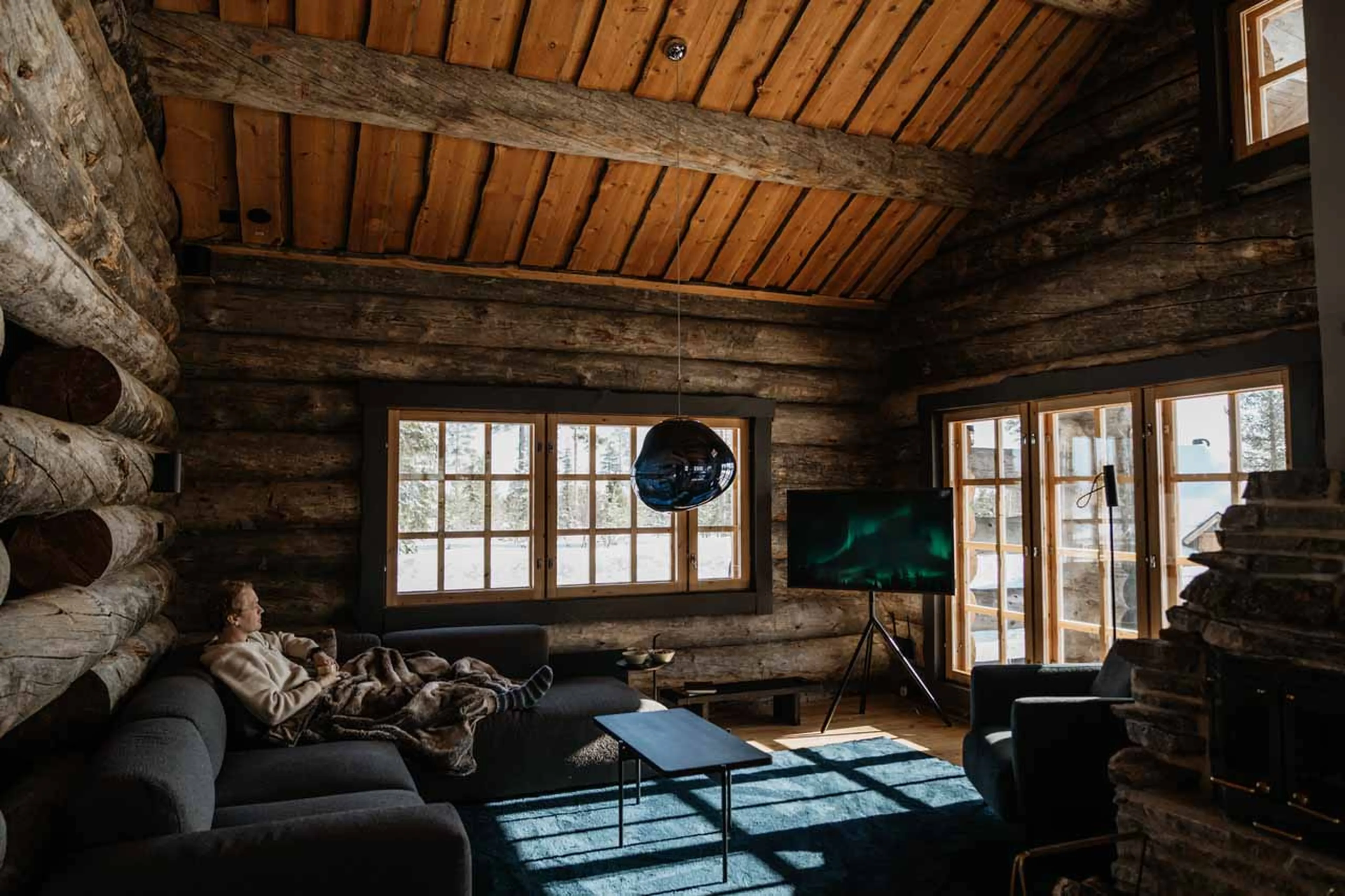 Cosy living area with sofas in The Fell Lodge, Finland