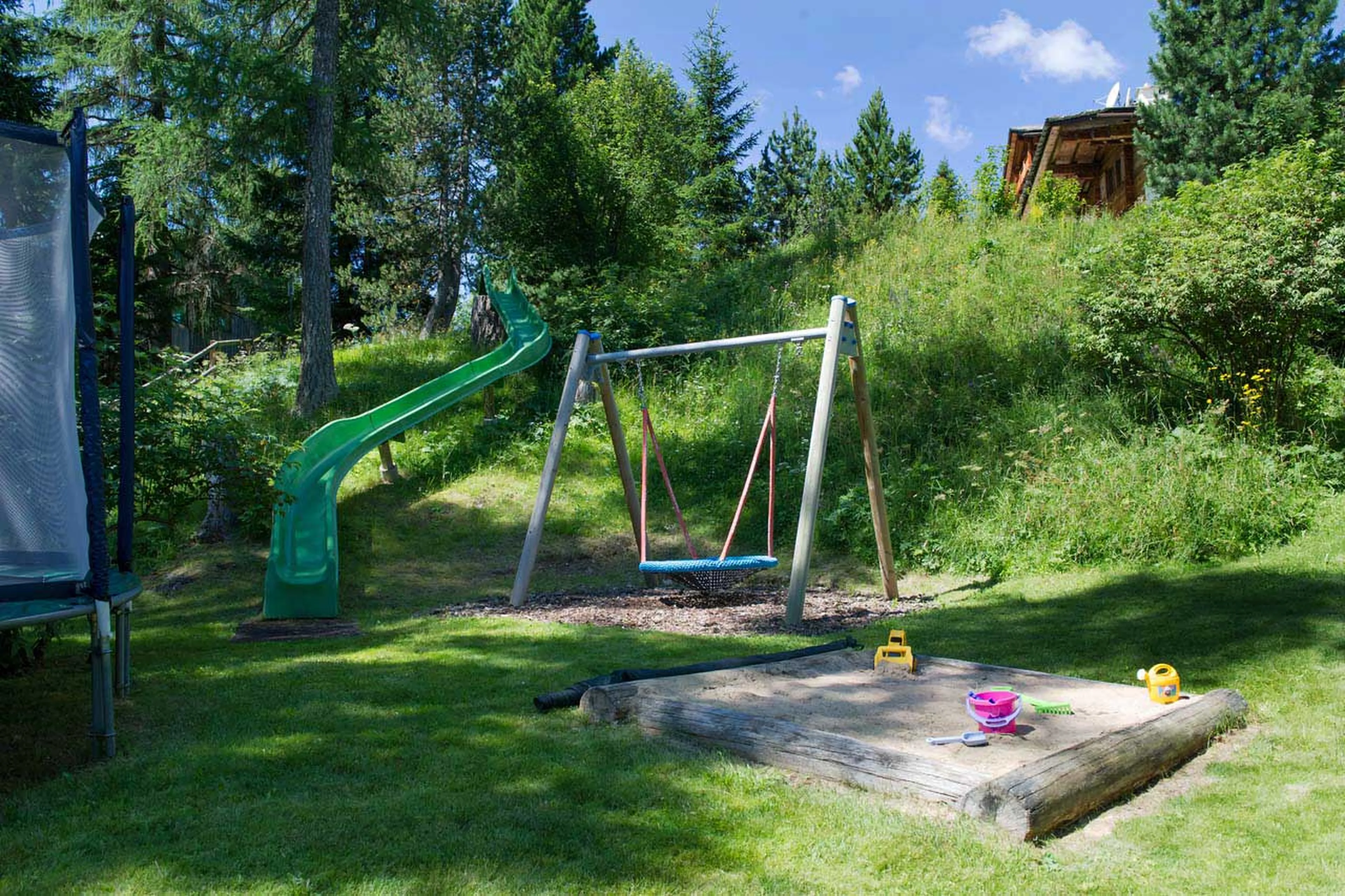 Children's playground in garden at Tivoli Lodge in Davos