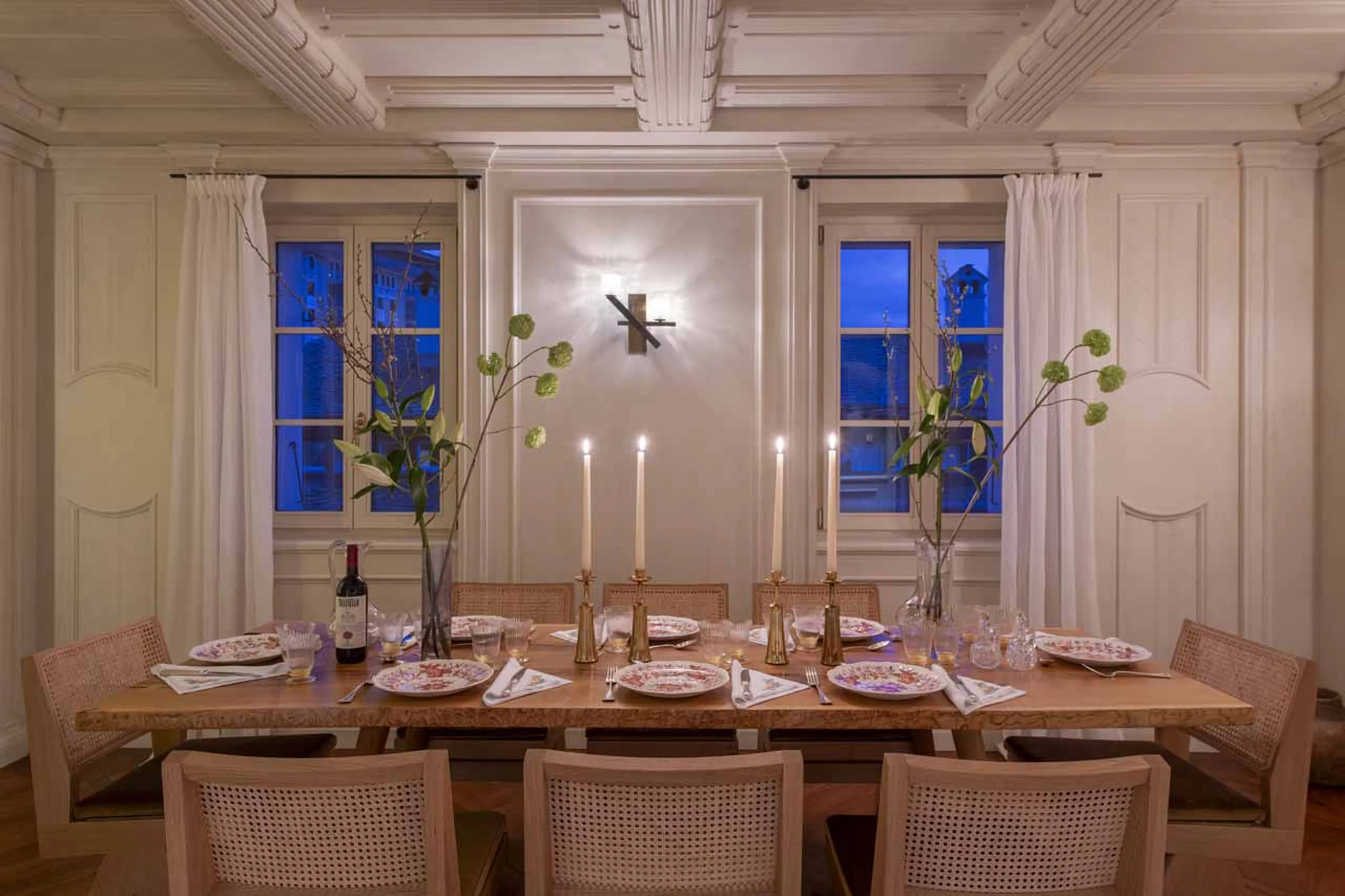 Dining table and chairs at night in Villa Erica 2, St Moritz