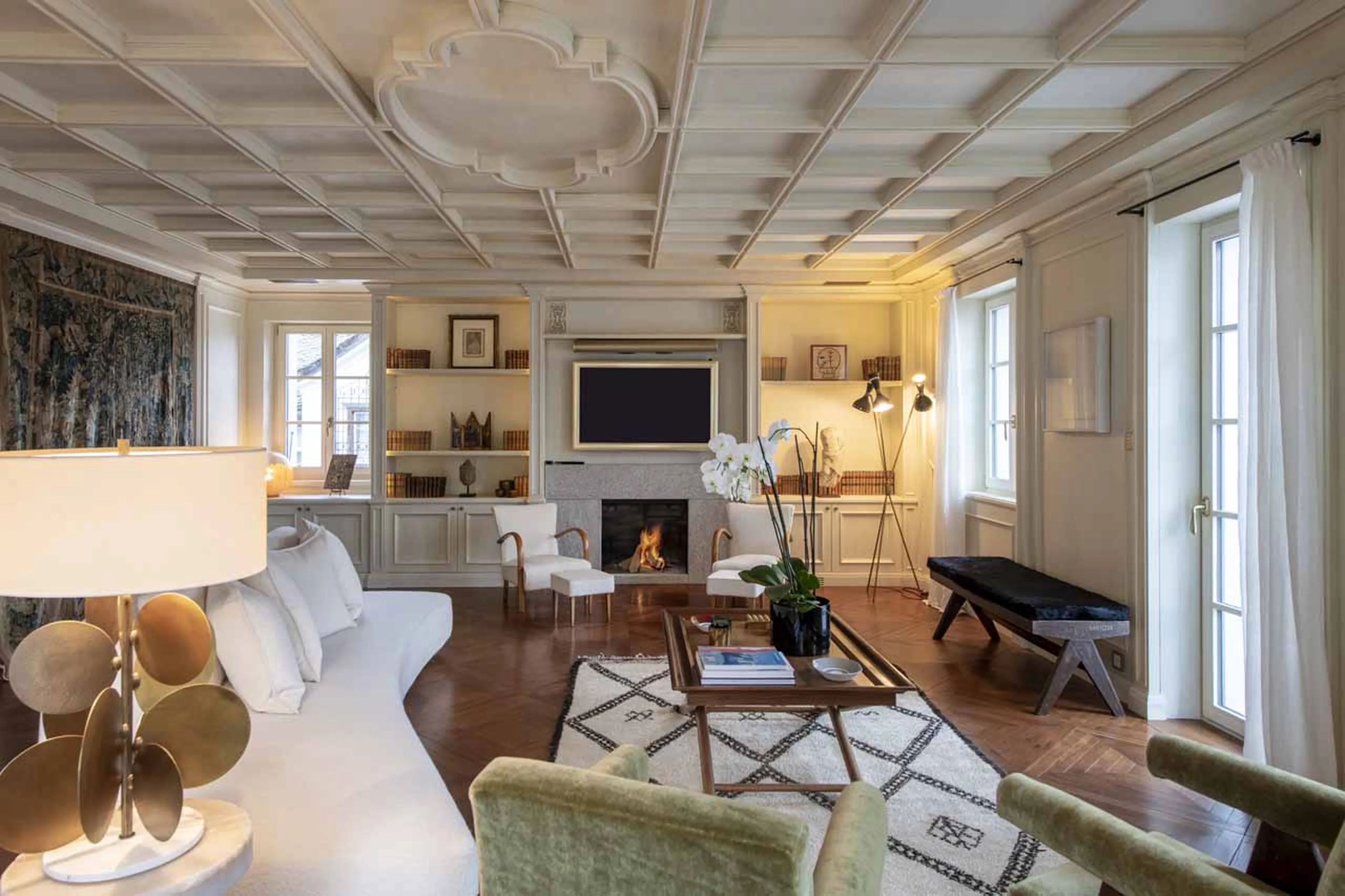 Sofas and coffee table in front of fireplace in Villa Erica 2, St Moritz